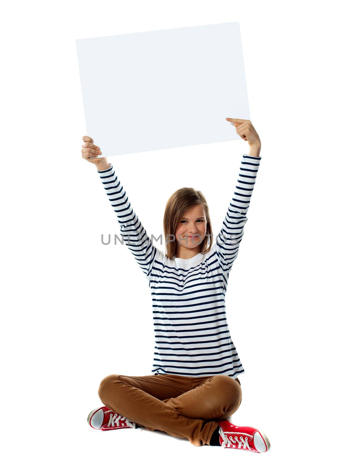 Gorgeous girl posing with blank white clipboard, seated on floor