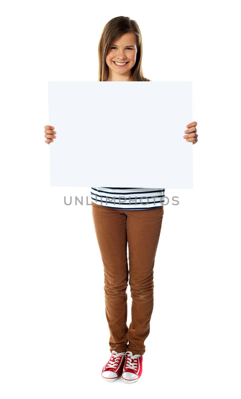 Smiling girl holding empty white board by stockyimages