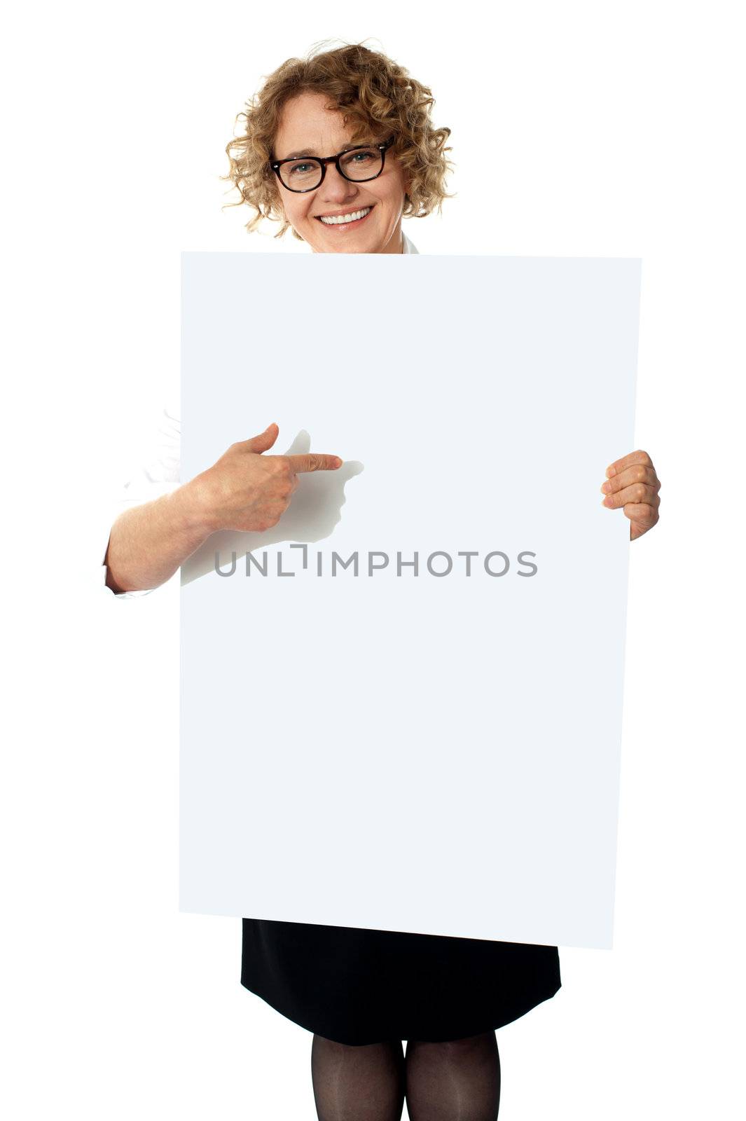 Female representative pointing towards placard, smiling at camera