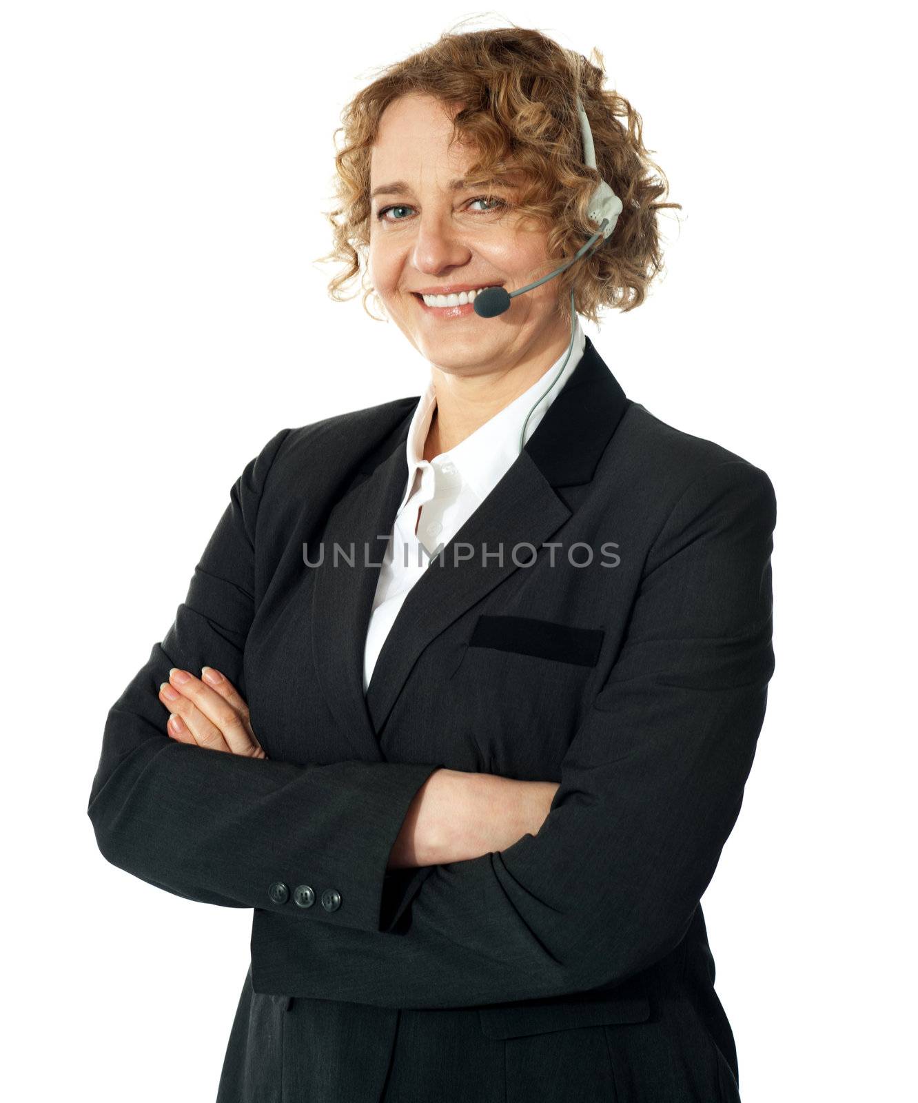 Smiling female operator with crossed arms by stockyimages