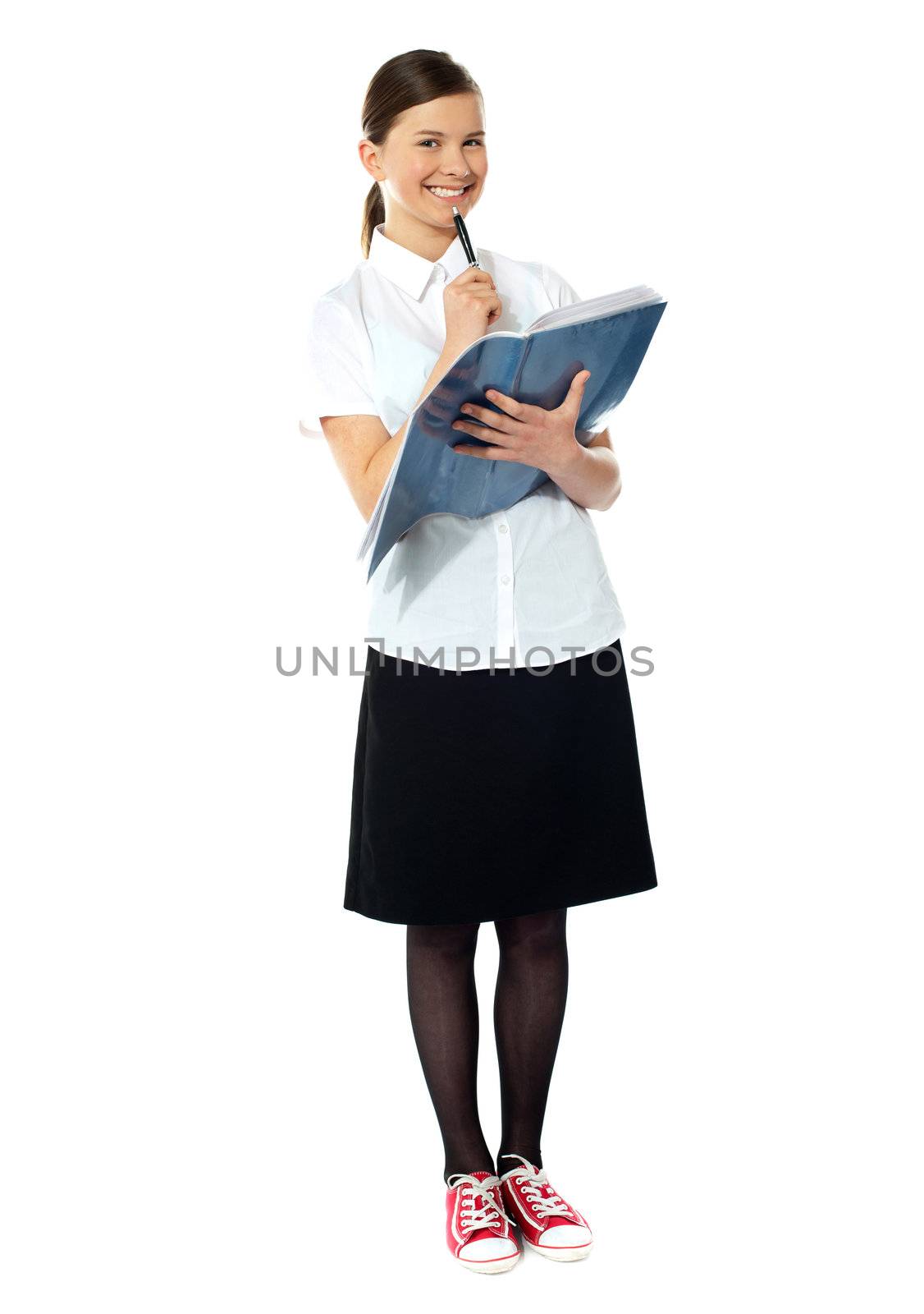 School girl thinking and smiling at camera by stockyimages