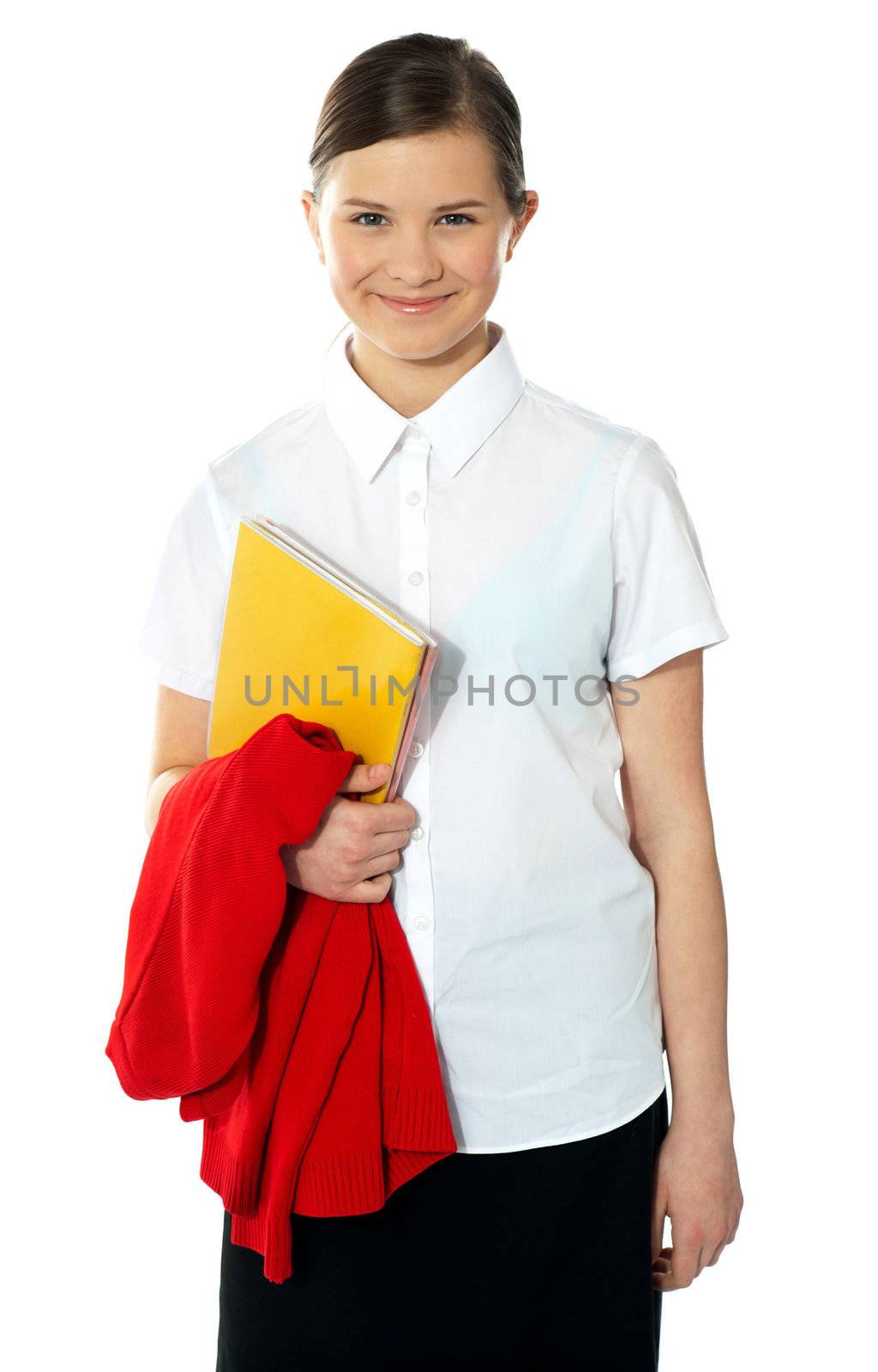 Portrait of happy school girl, posing with book in hand and sweater on arm