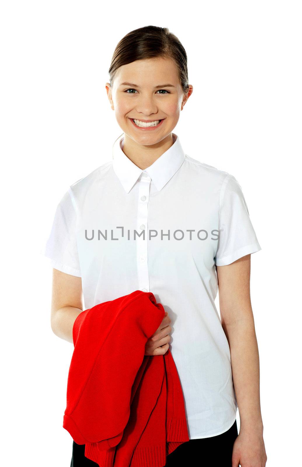 School girl holding her red sweater and smiling, isolated on white background