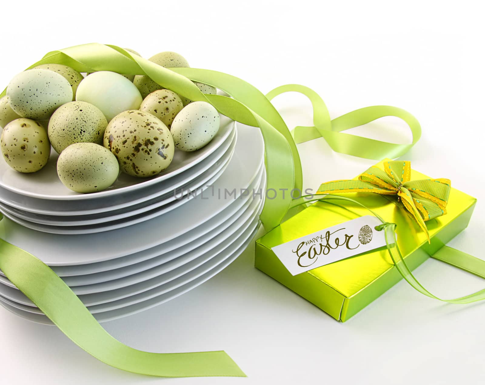 Easter eggs on plates with ribbons and gift by Sandralise