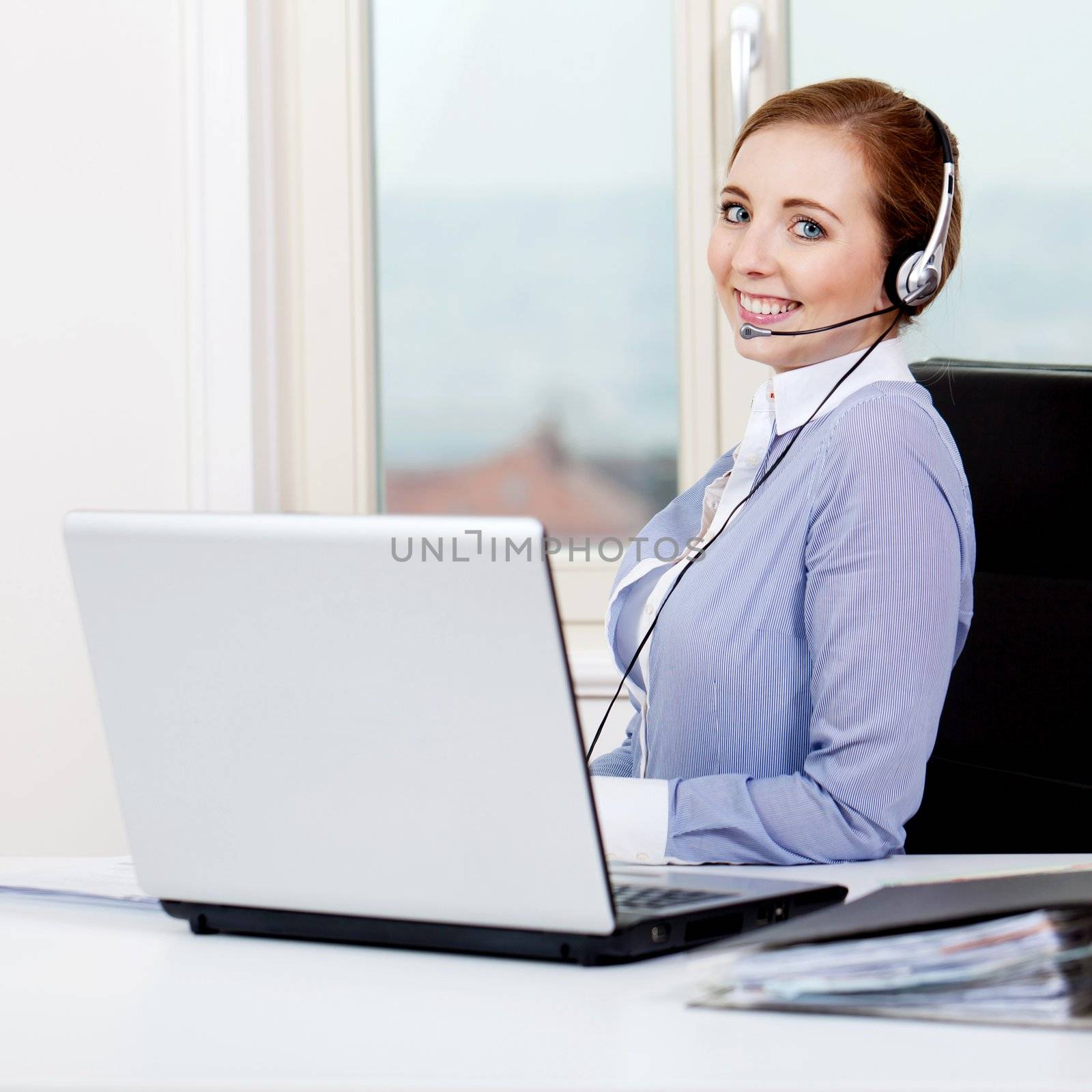 smiling young female callcenter agent with headset by juniart