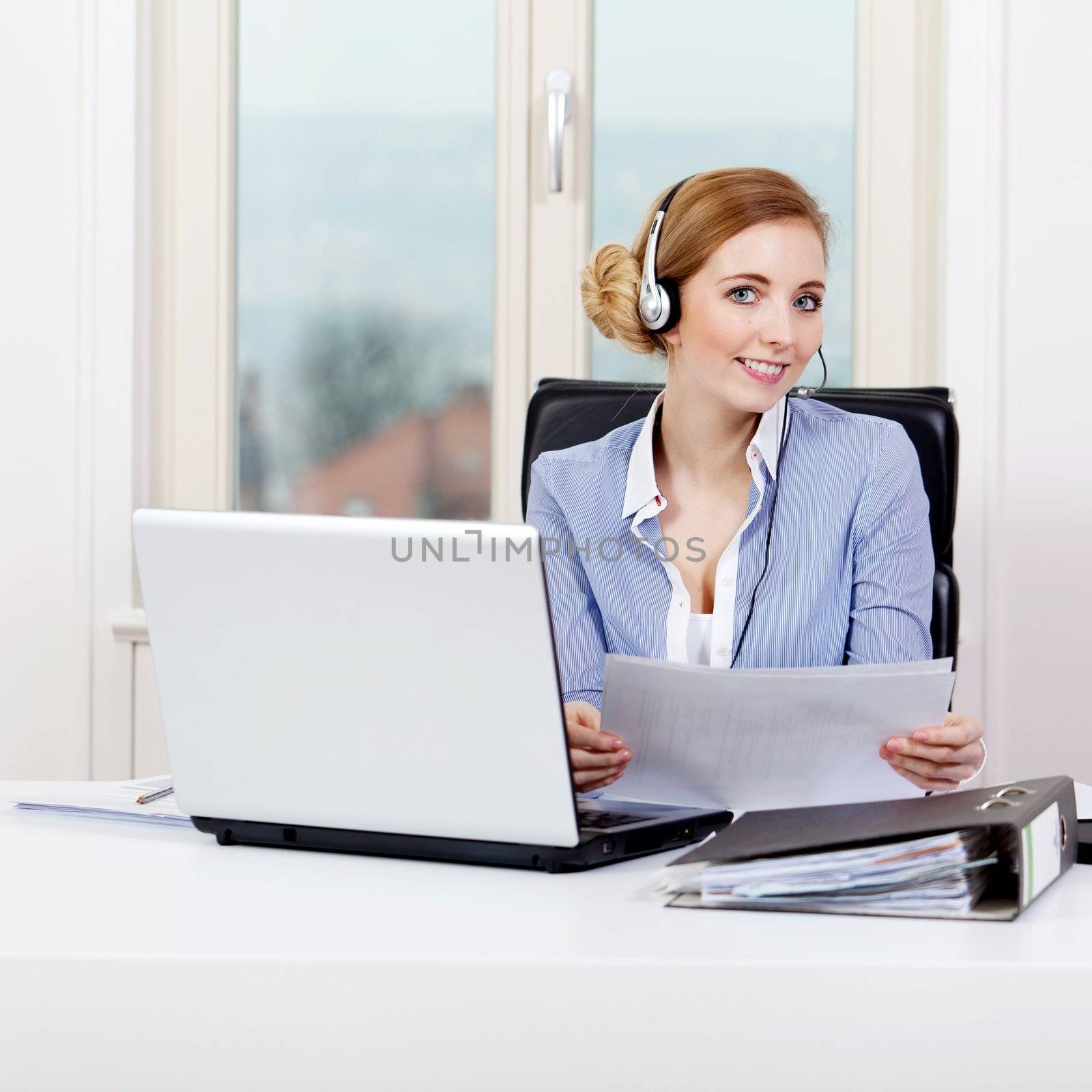 smiling young female callcenter agent with headset by juniart