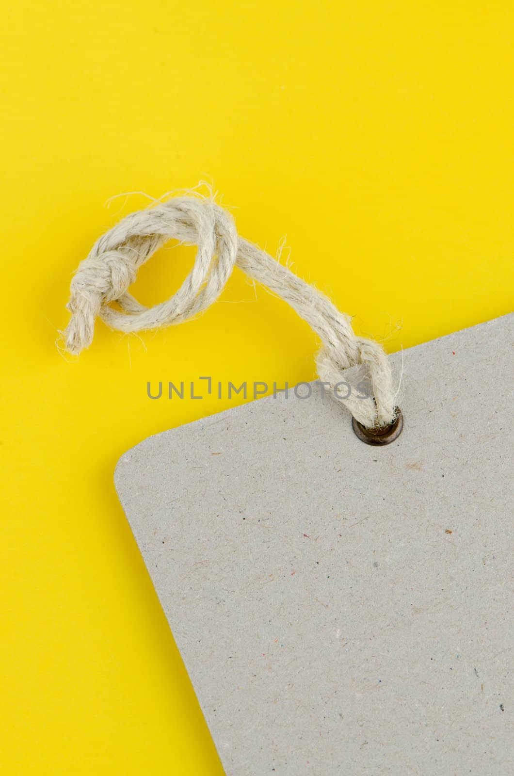 Closeup of blank product info label on yellow background.