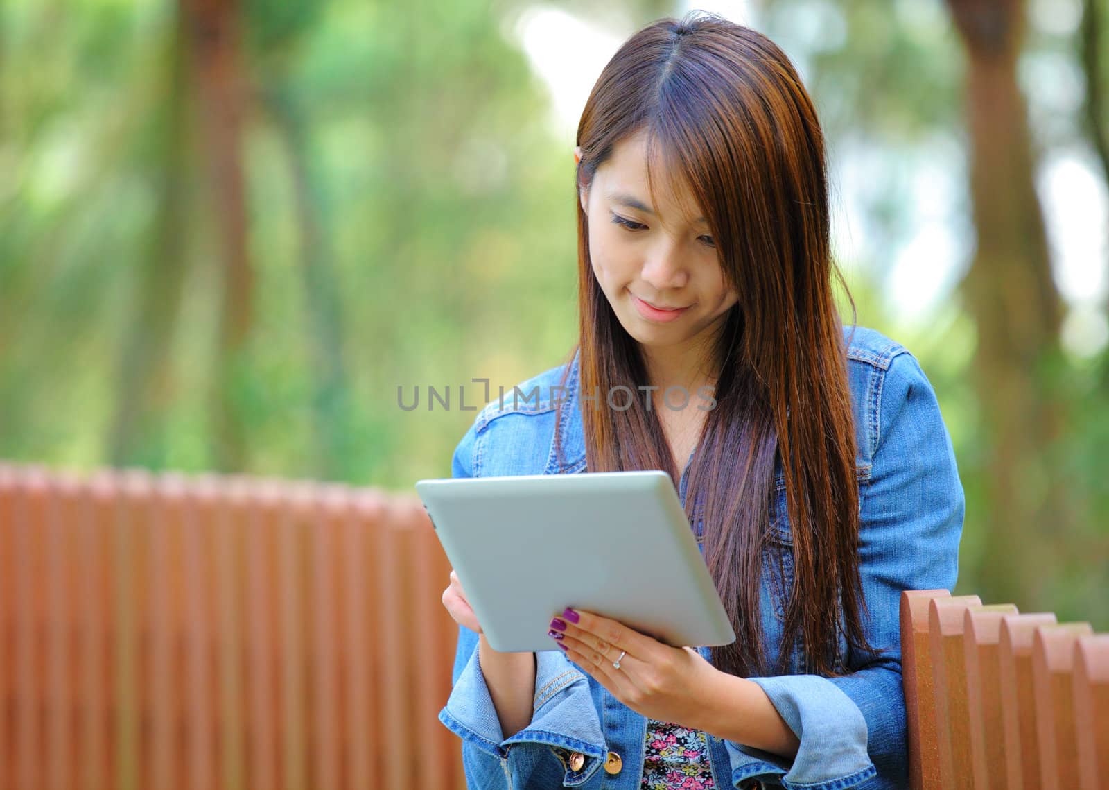 young asian woman with tablet computer by leungchopan