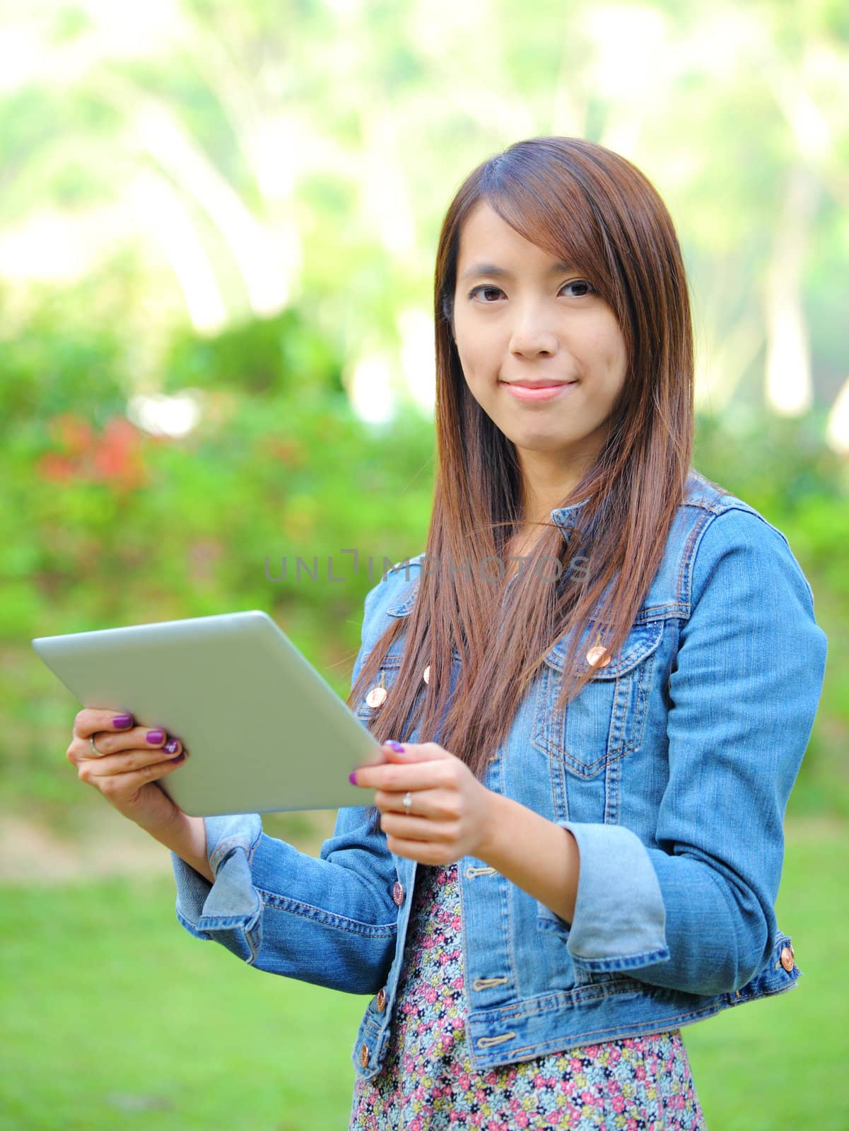 young asian woman with tablet computer by leungchopan