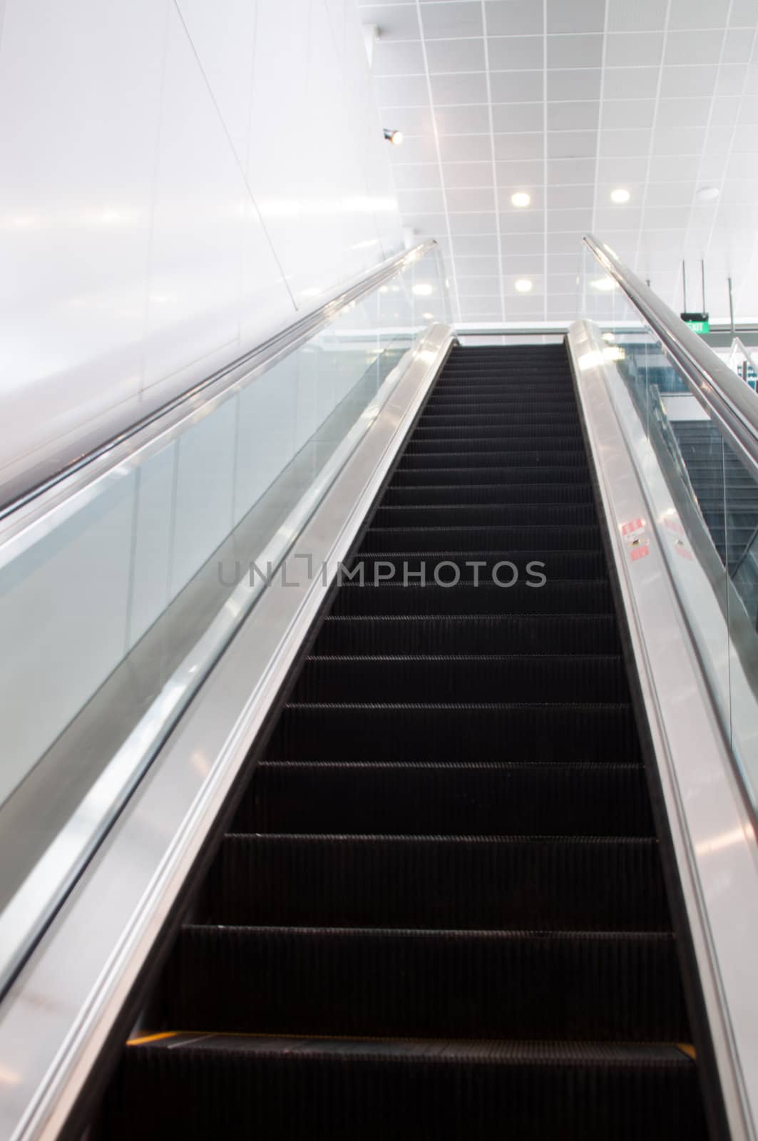Modern escalator moving up with bright colours