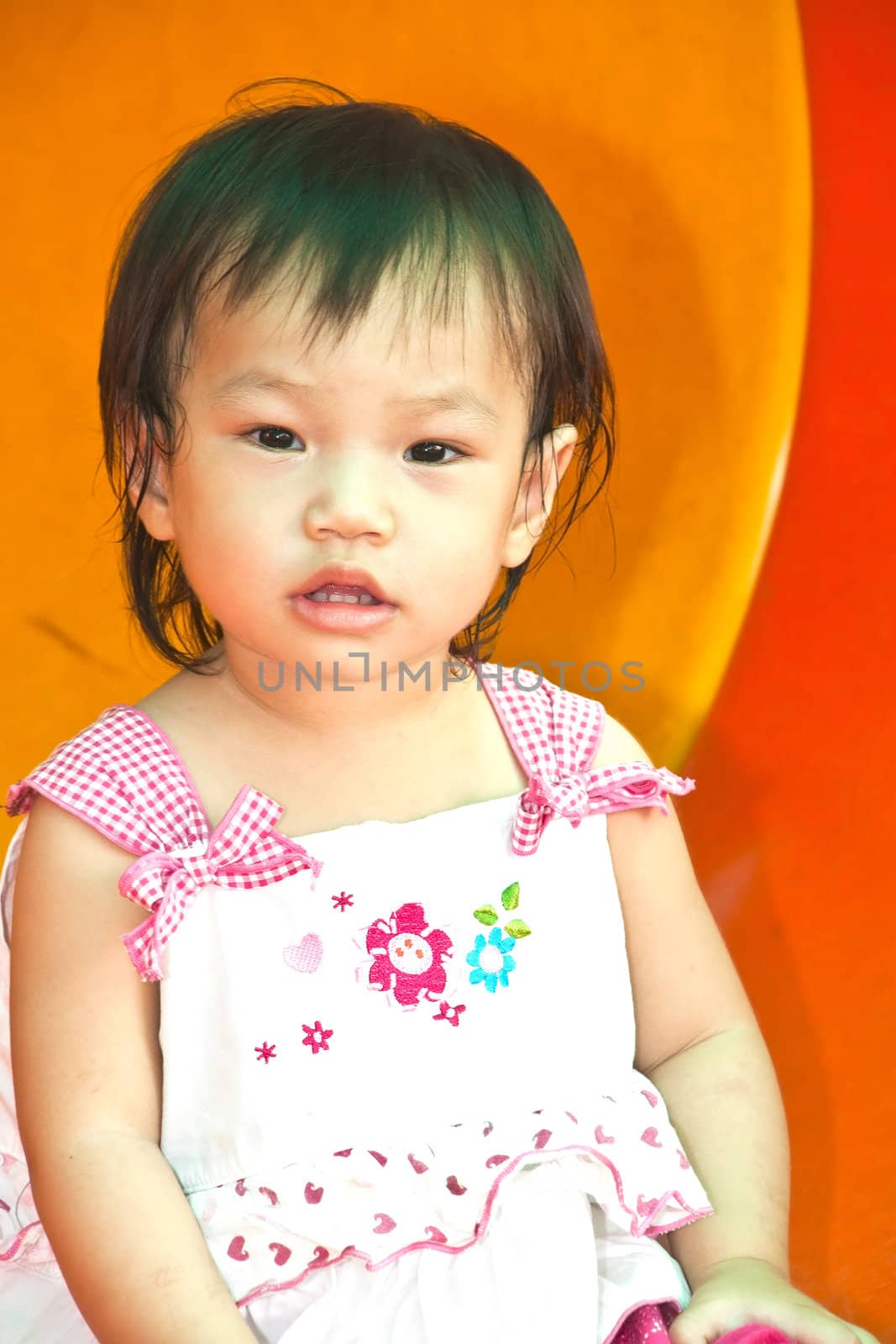 A Happy Asian Little baby girl flower on White Uniform of playground