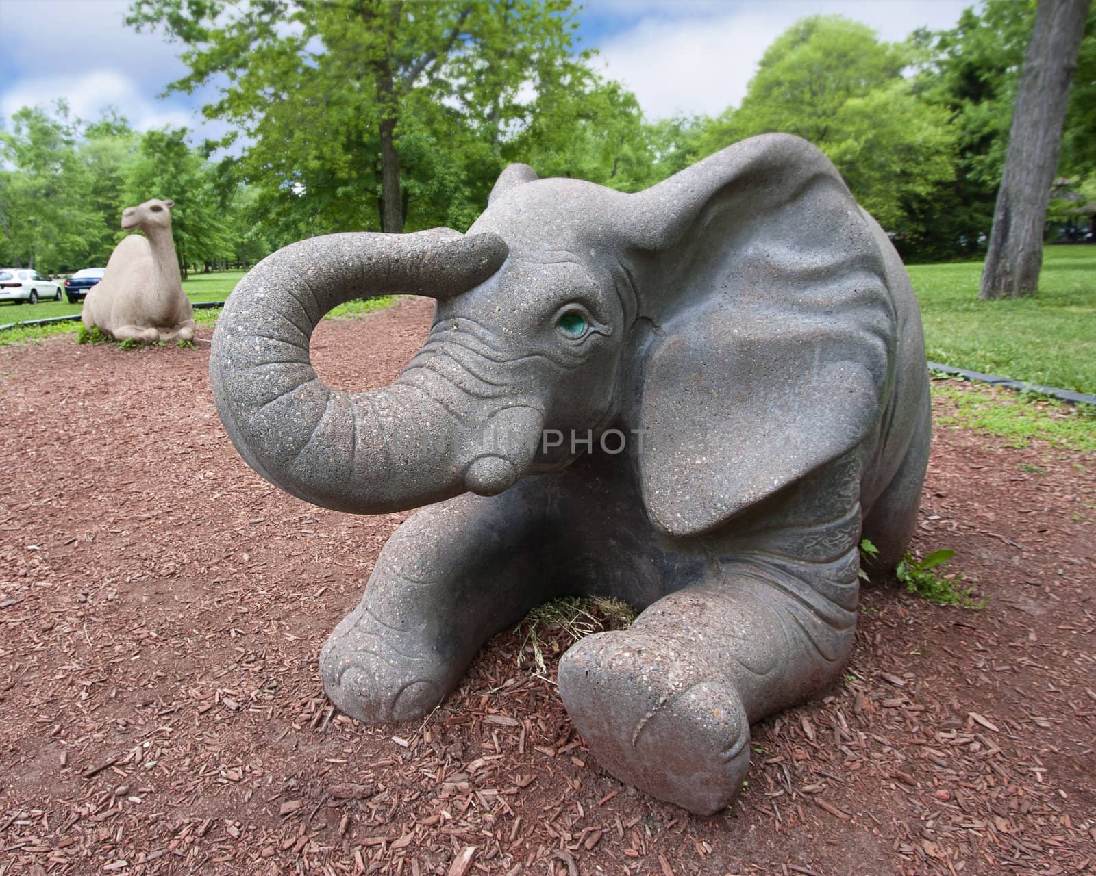 A large elephant statue in a children's playground 