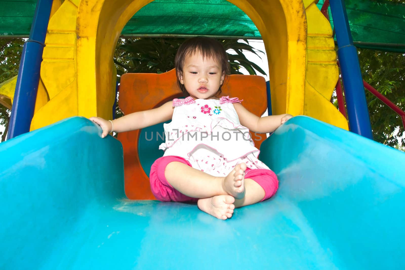 A Happy Asian Little baby girl flower on White Uniform of playground