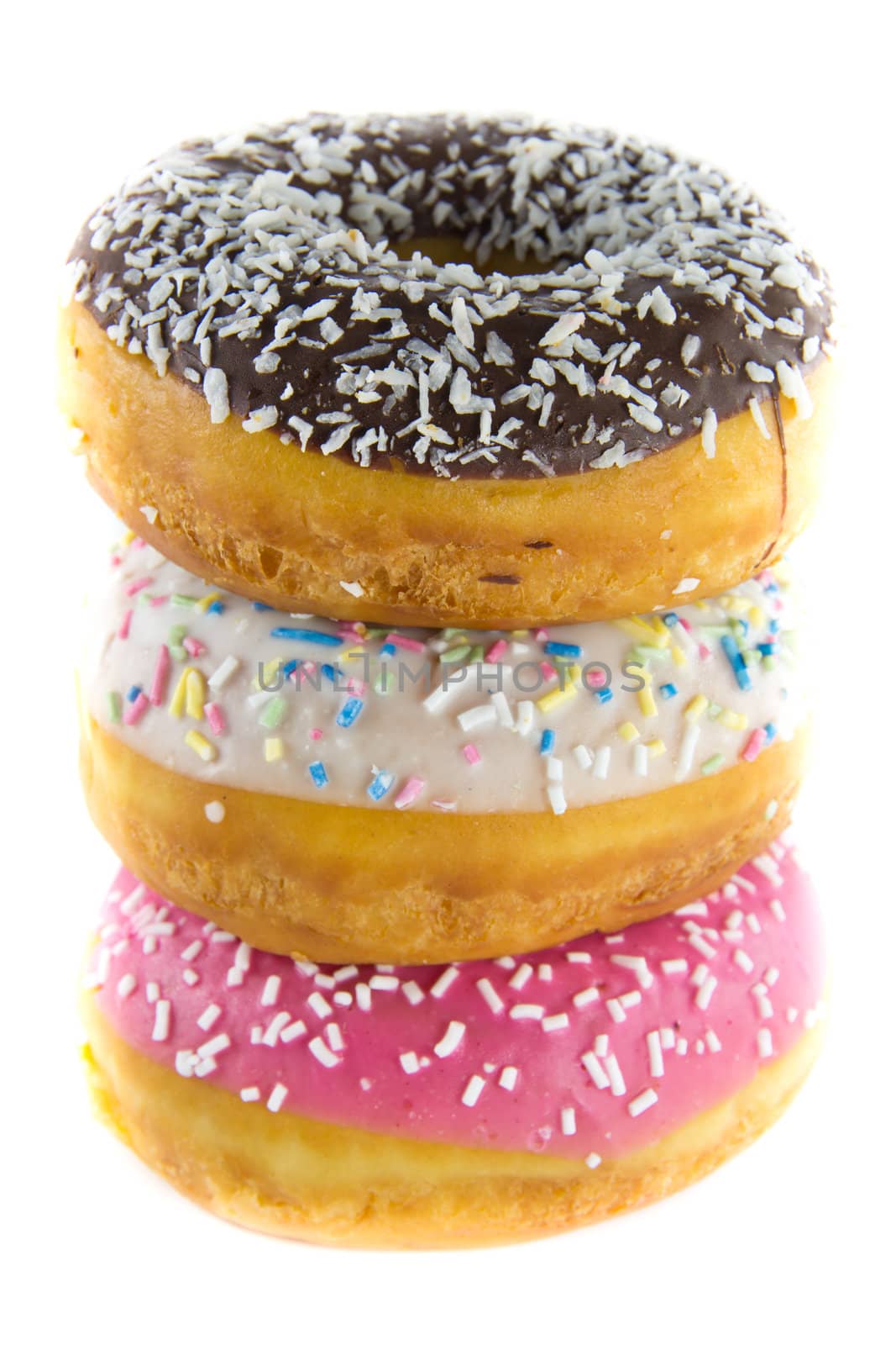 Close up picture of three stacked donuts on a white background
