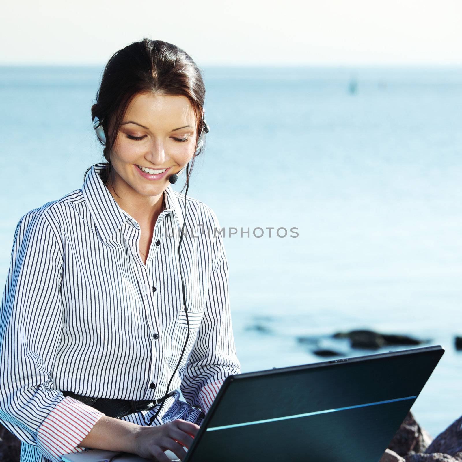 woman work on laptop sea on background