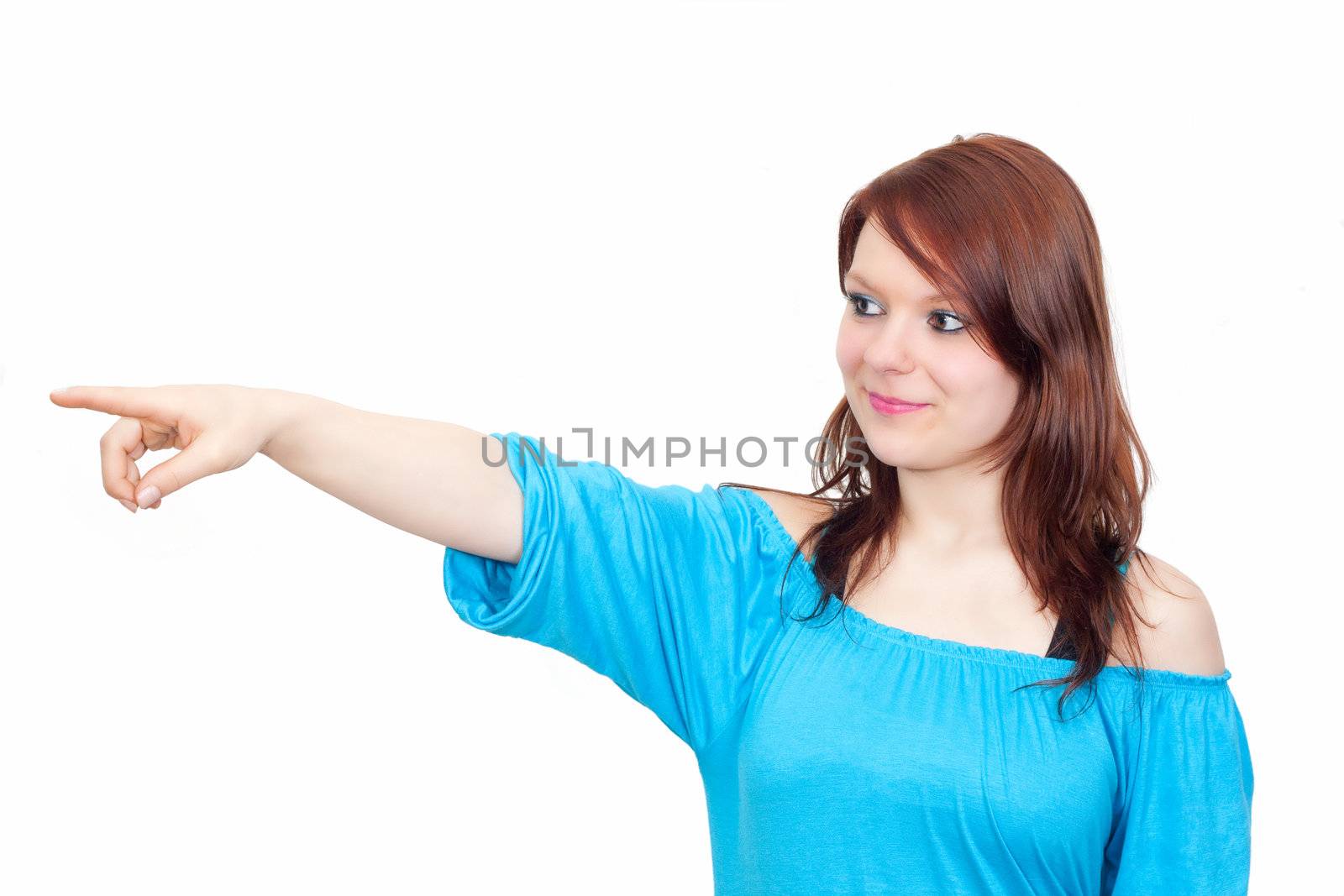 Young business woman in blue is pointing towards copyspace