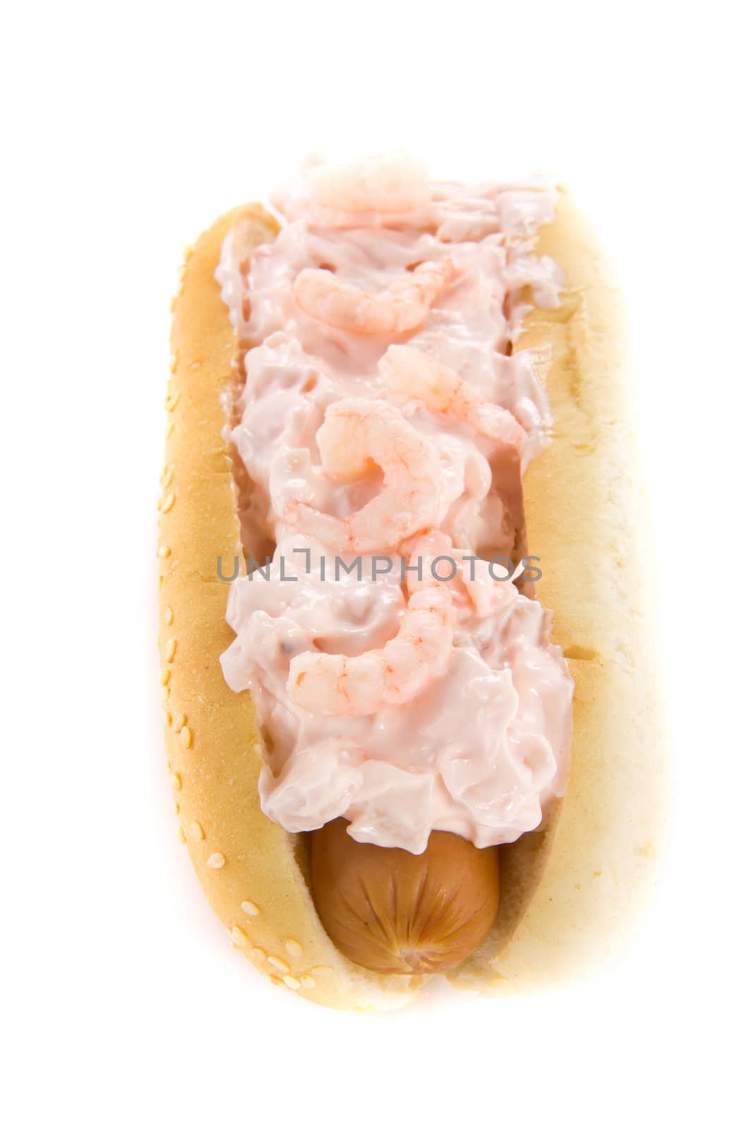 A picture of a hotdog with shrimp salad on top
