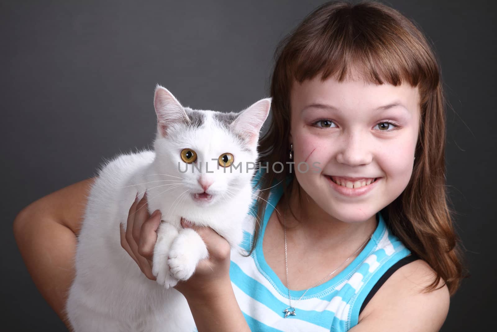 the girl and white cat play. close up. double 6