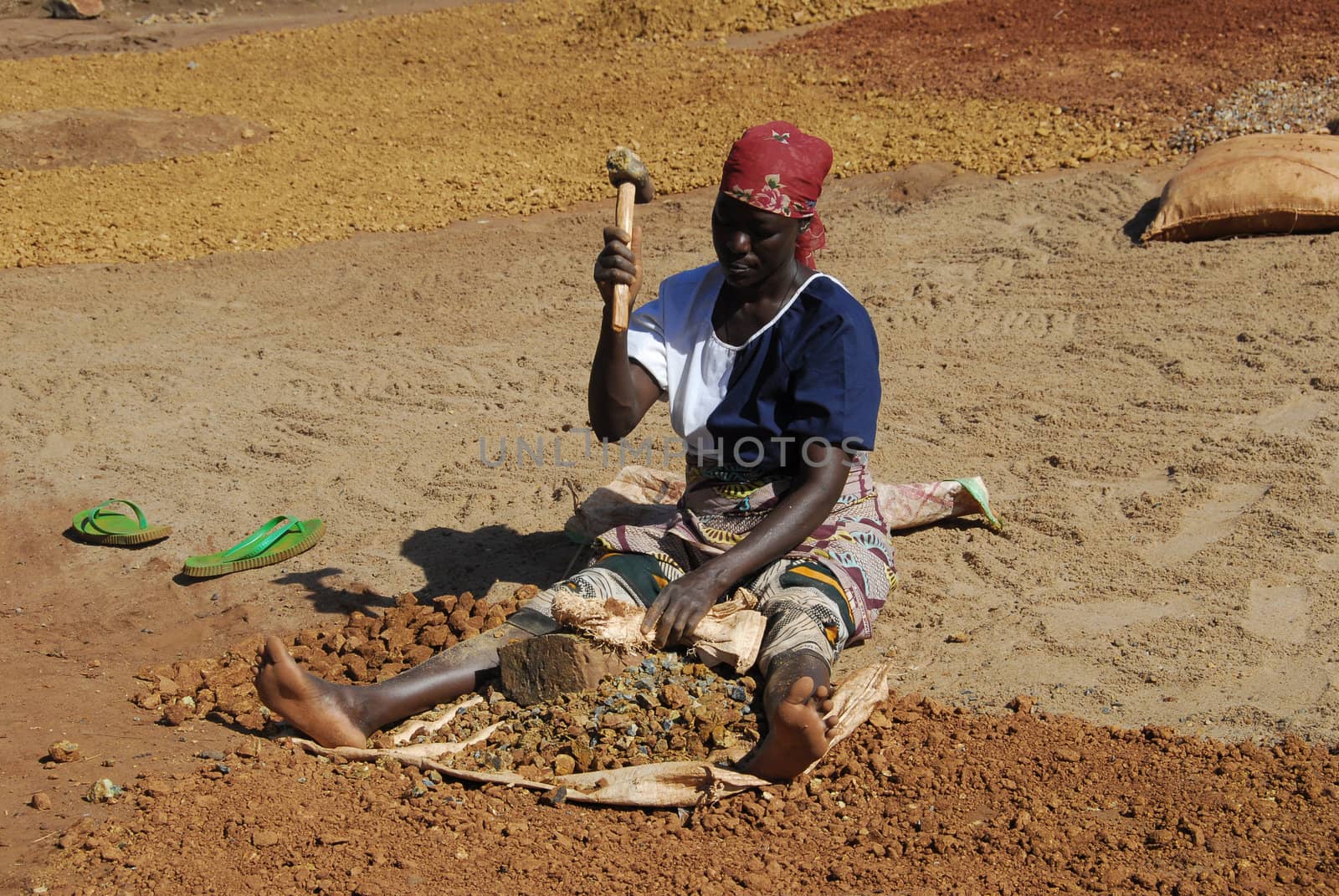 Shinyanga, Tanzania March 18, 2010: woman miner quarries stones. Prepare gravel quarries to be sold for a dollar a day. To them it was the only occupation to feed their families