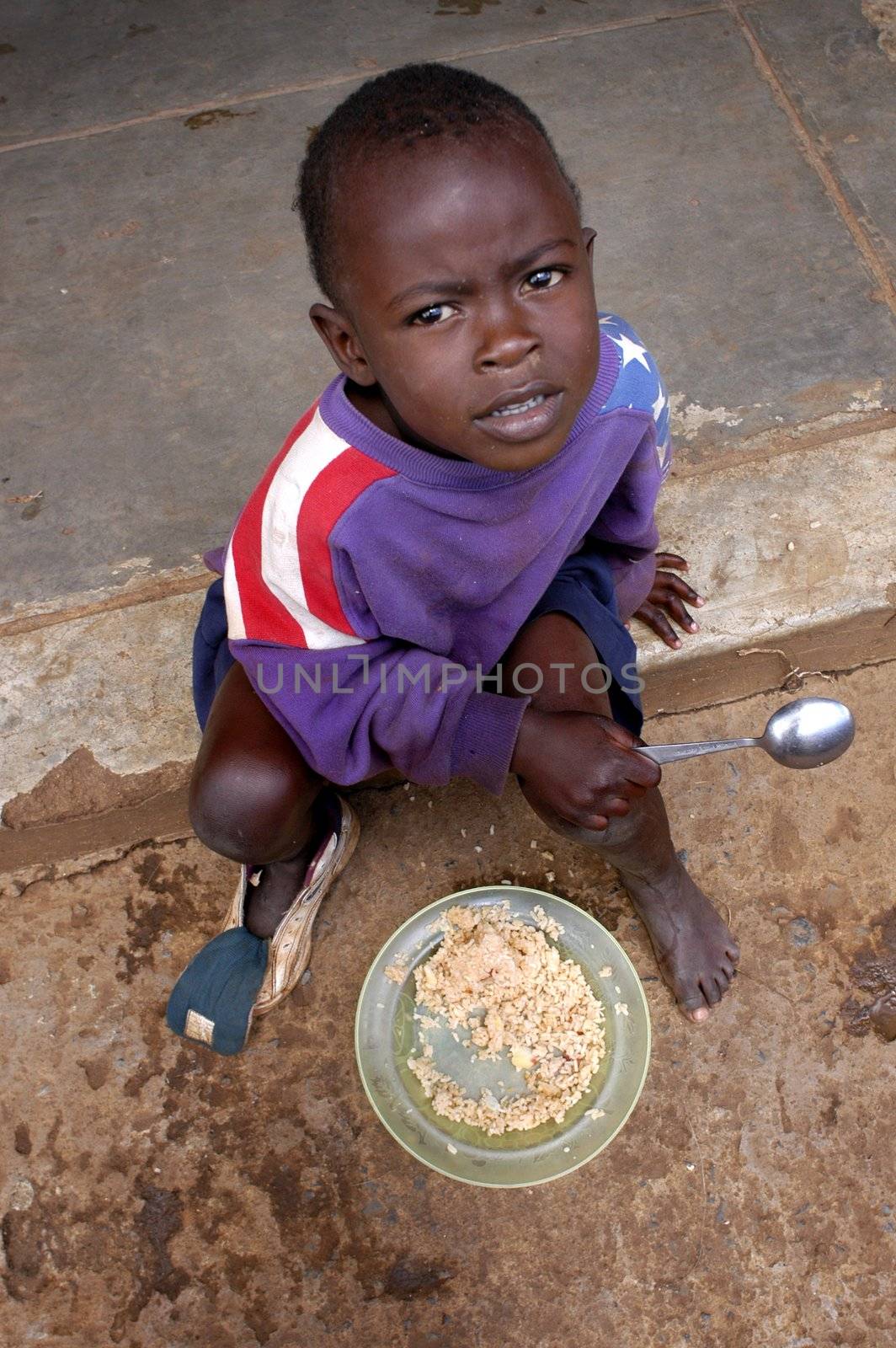 Nairobi, Kenya January 17 2004. child eats in the streets of Nairobi.There are many children abandoned in the streets alone