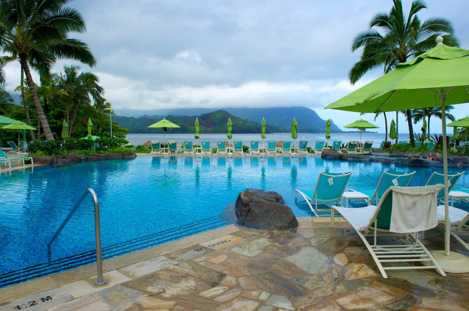 By the pool at a resort on the Hawaiian island of Kauai. The pool has an incredibly beautiful view of Hanalei Bay