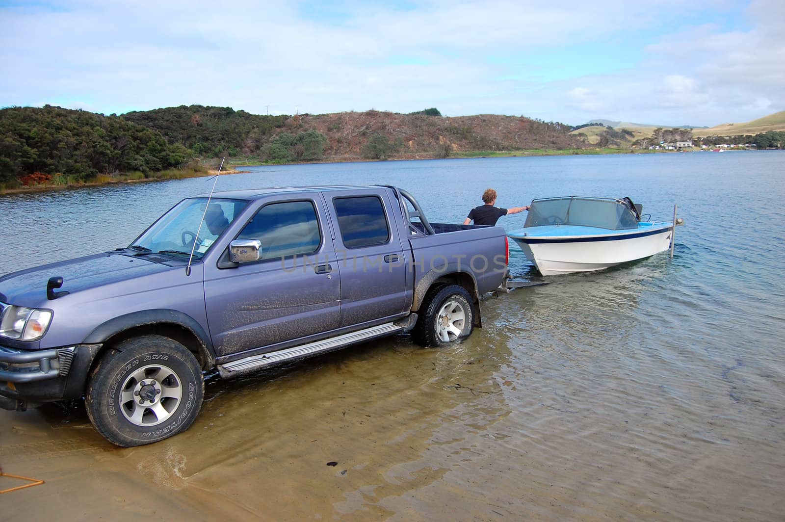 Car with boat trailer at lake, New Zealand