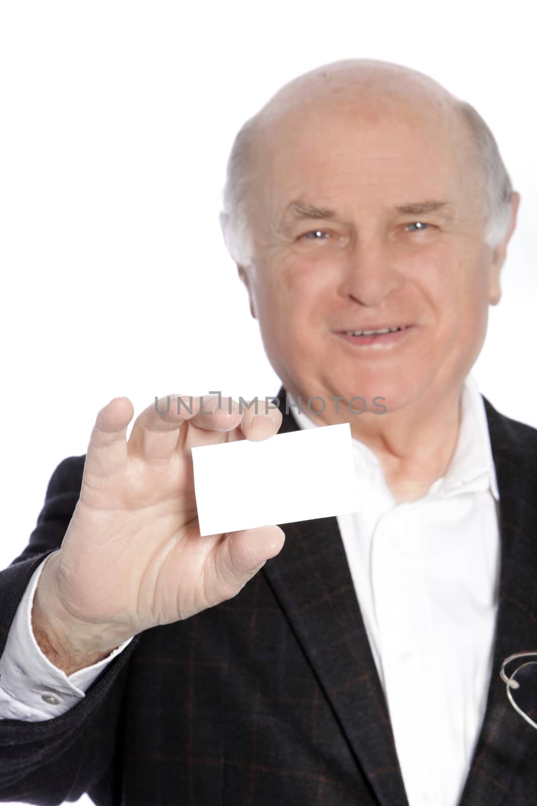 Smiling senior businessman in a suit presenting his blank white business card for your attention
