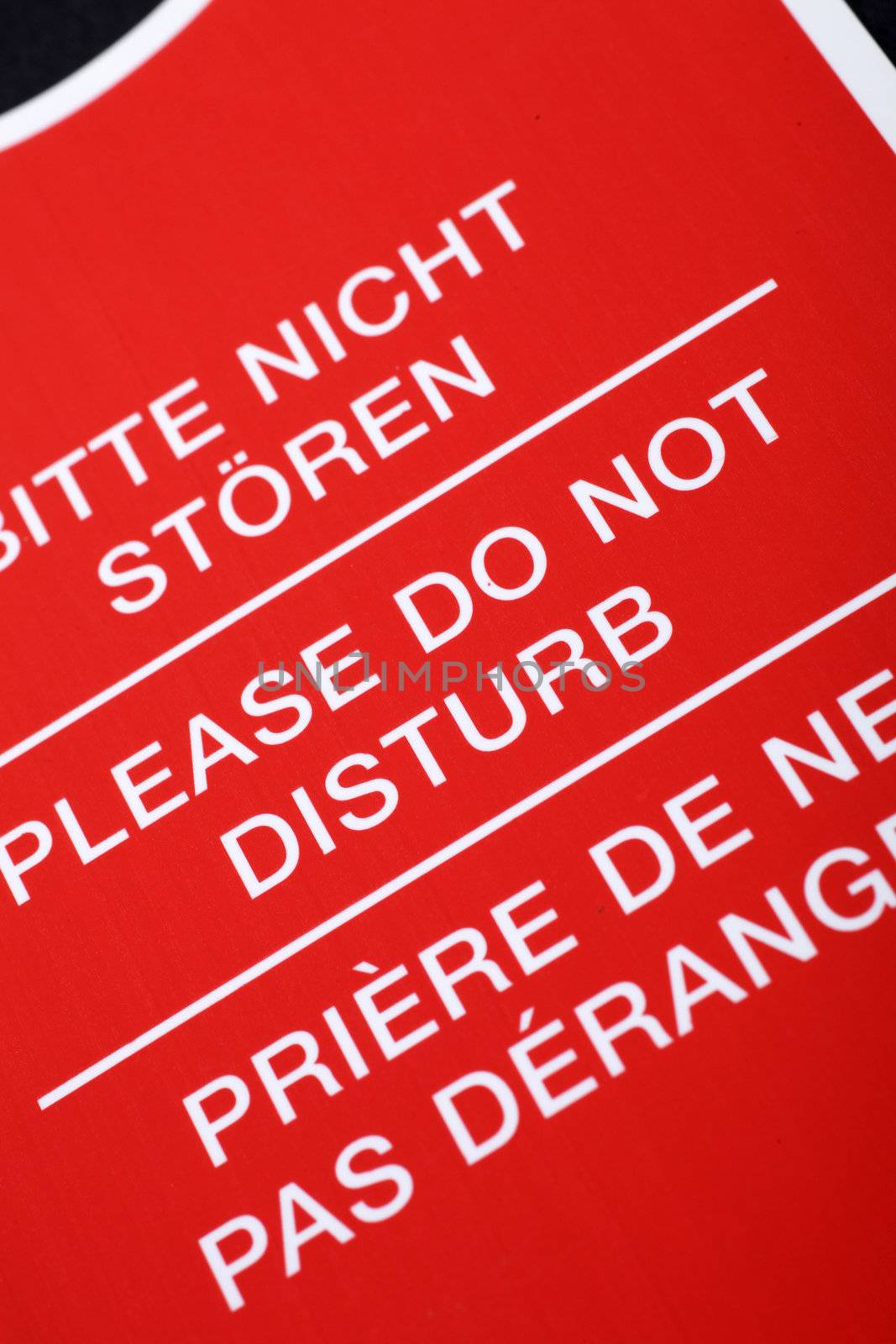 "Do not disturb!" sign written in different languages, close up