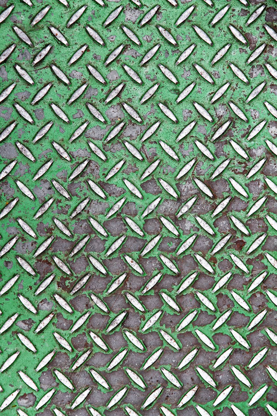 A metal floor background. Tiled steel with green a paint.