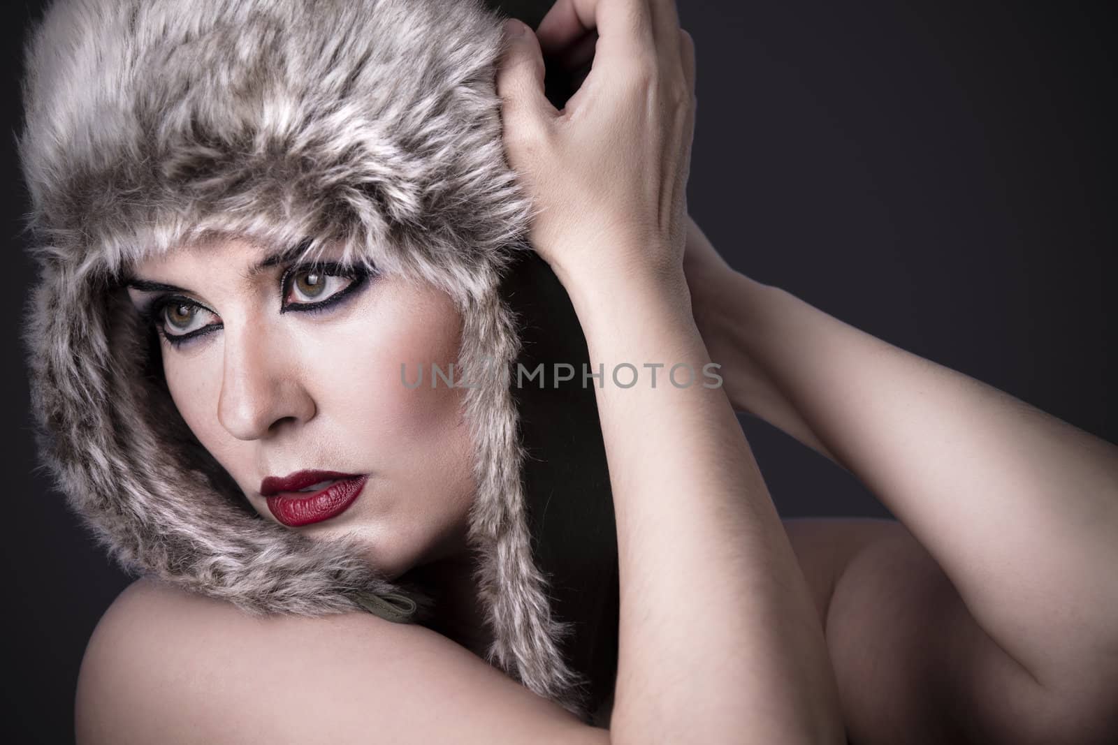 a beauty brunette girl with snow hat on the winter background by FernandoCortes
