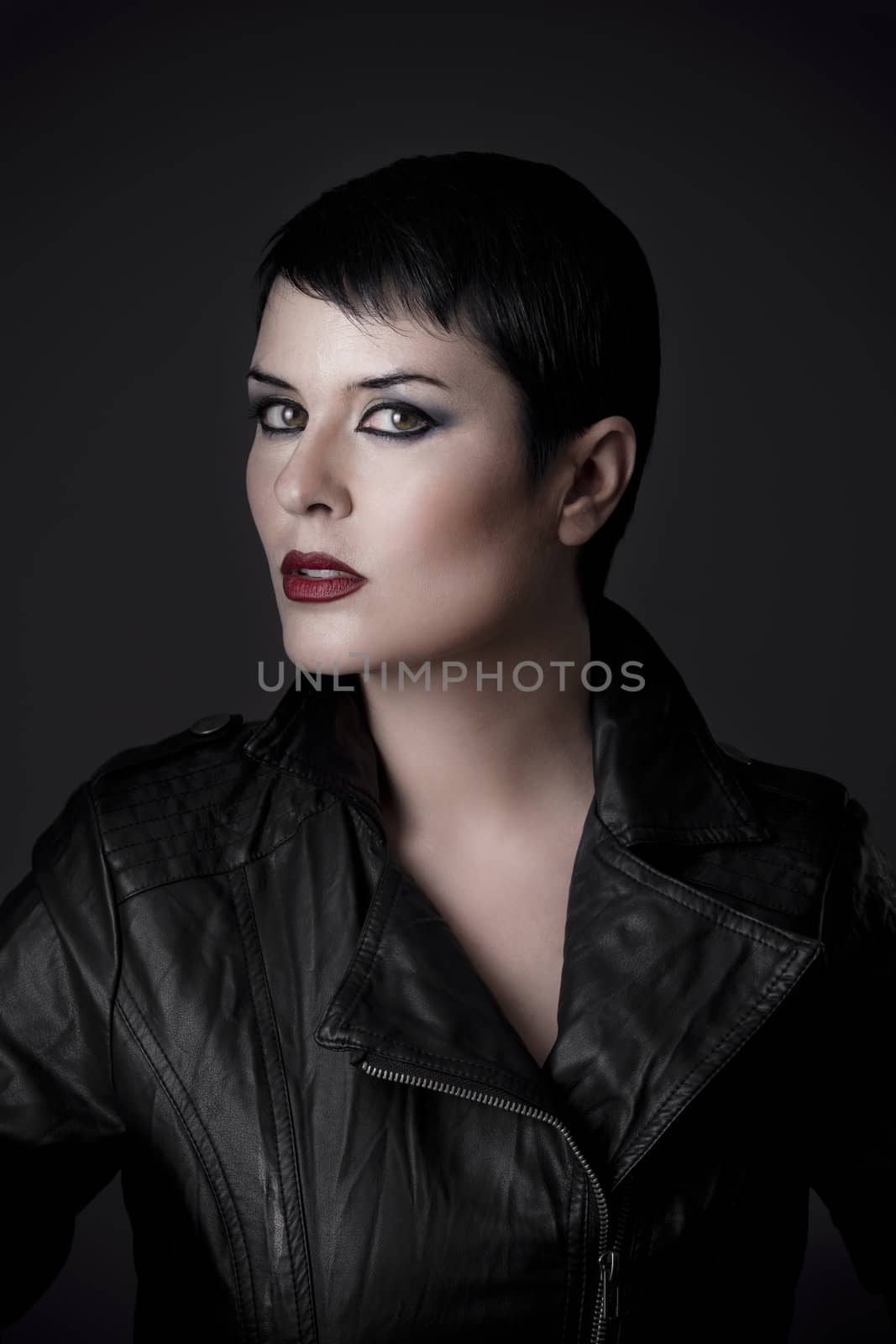 young woman in leather jacket, studio shot over black background by FernandoCortes