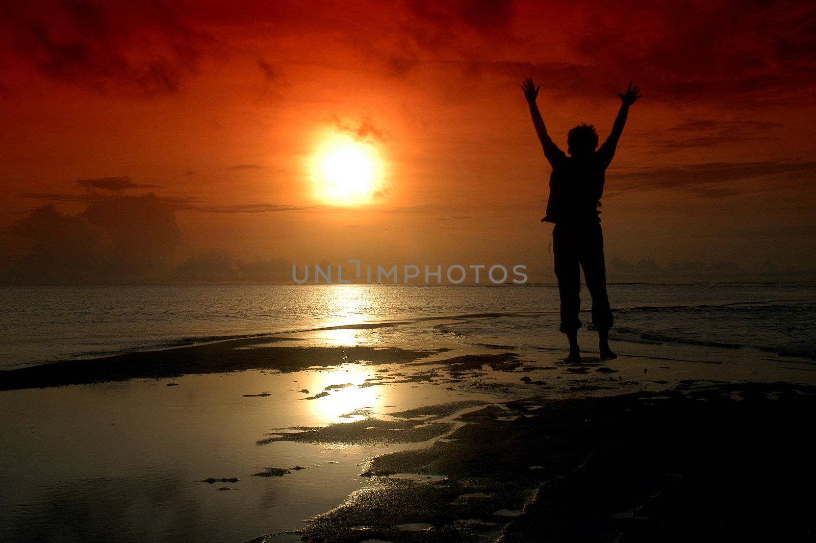 Silhouette of a man who jumped into the direction of the sun 