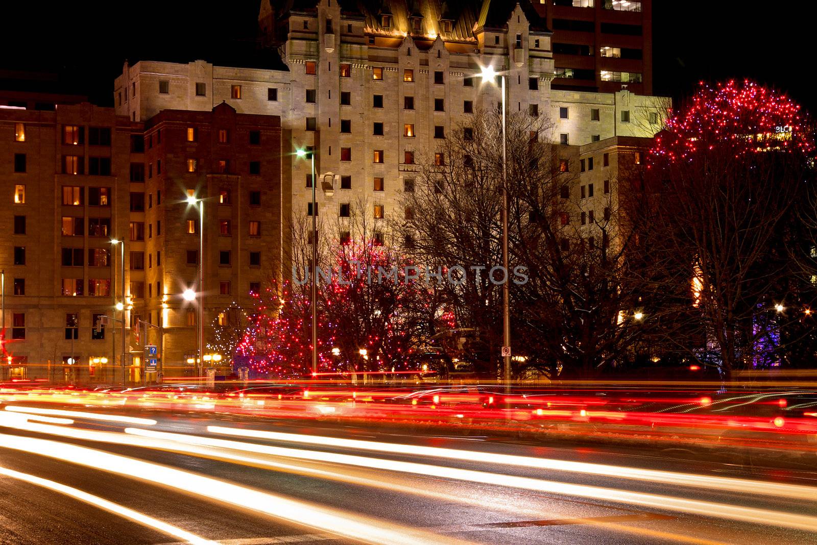 A night shot of car light trails on the street.