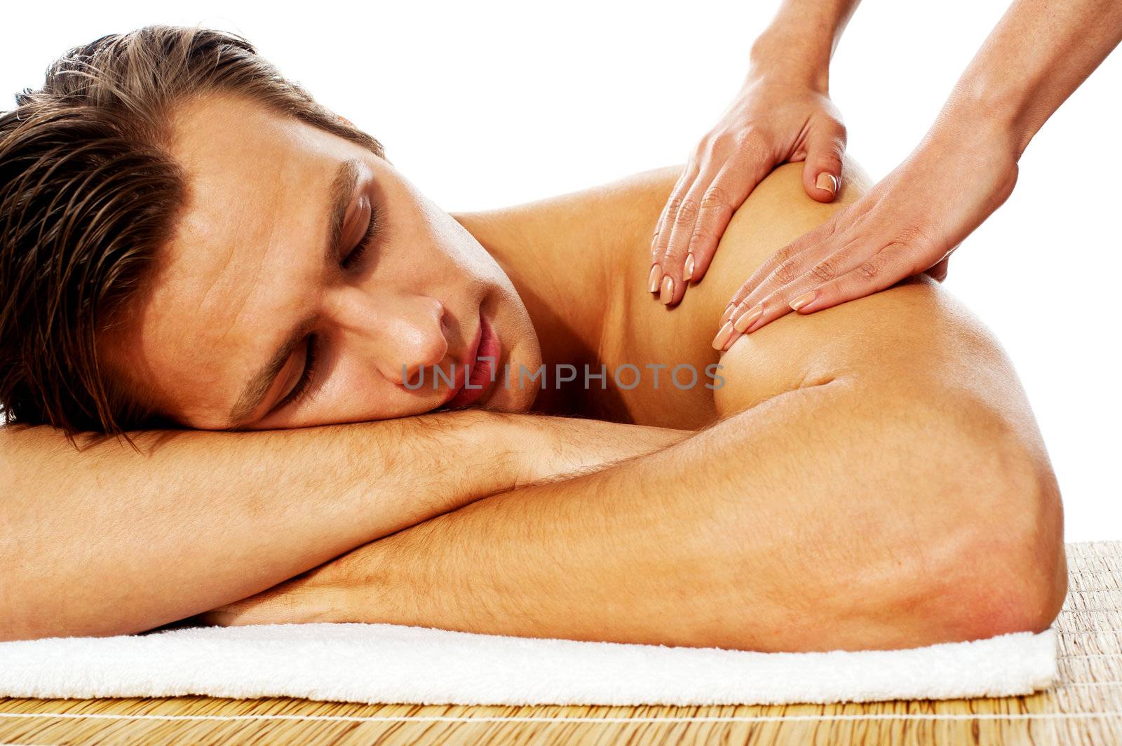 Close-up of an attractive man enjoying a back massage in a spa center