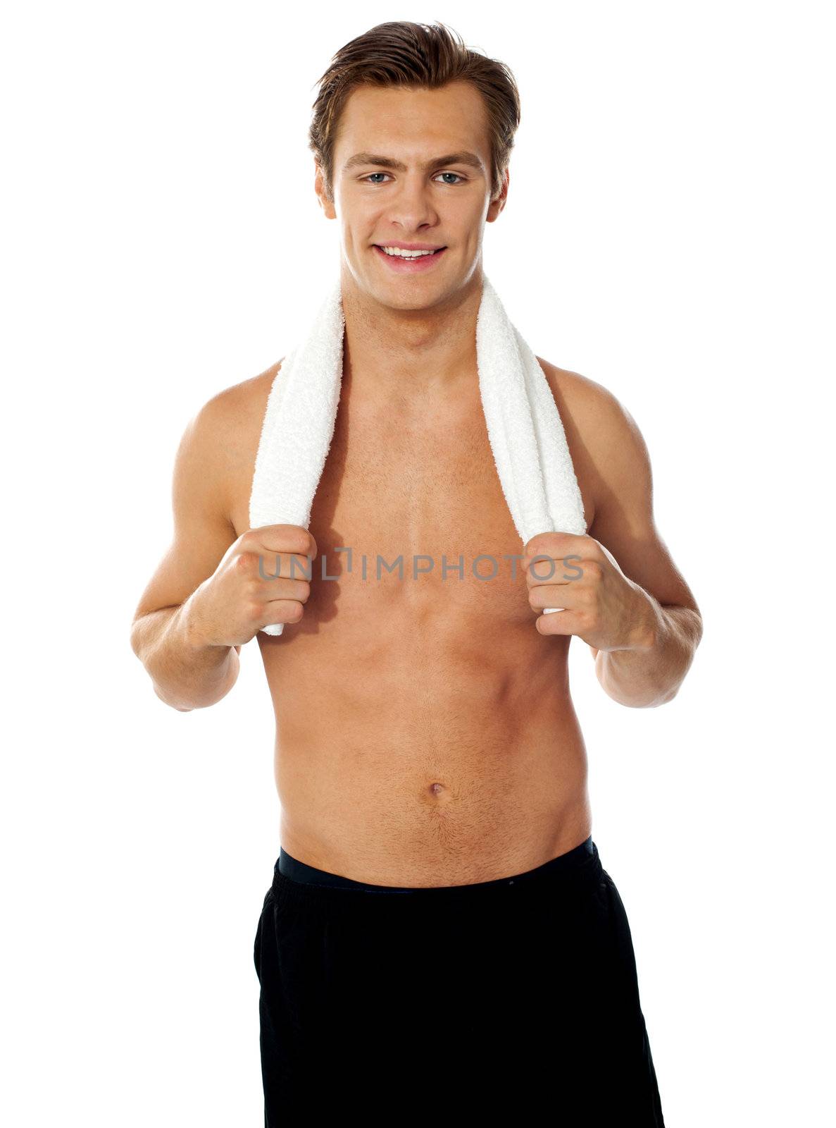 Sexy muscular man with a towel over his shoulders against white background