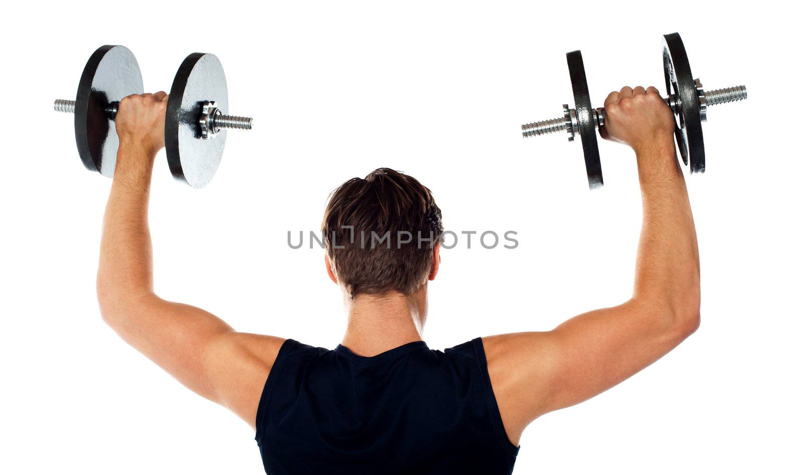 Rear view of a young male bodybuilder doing heavy weight exercise with dumbbells