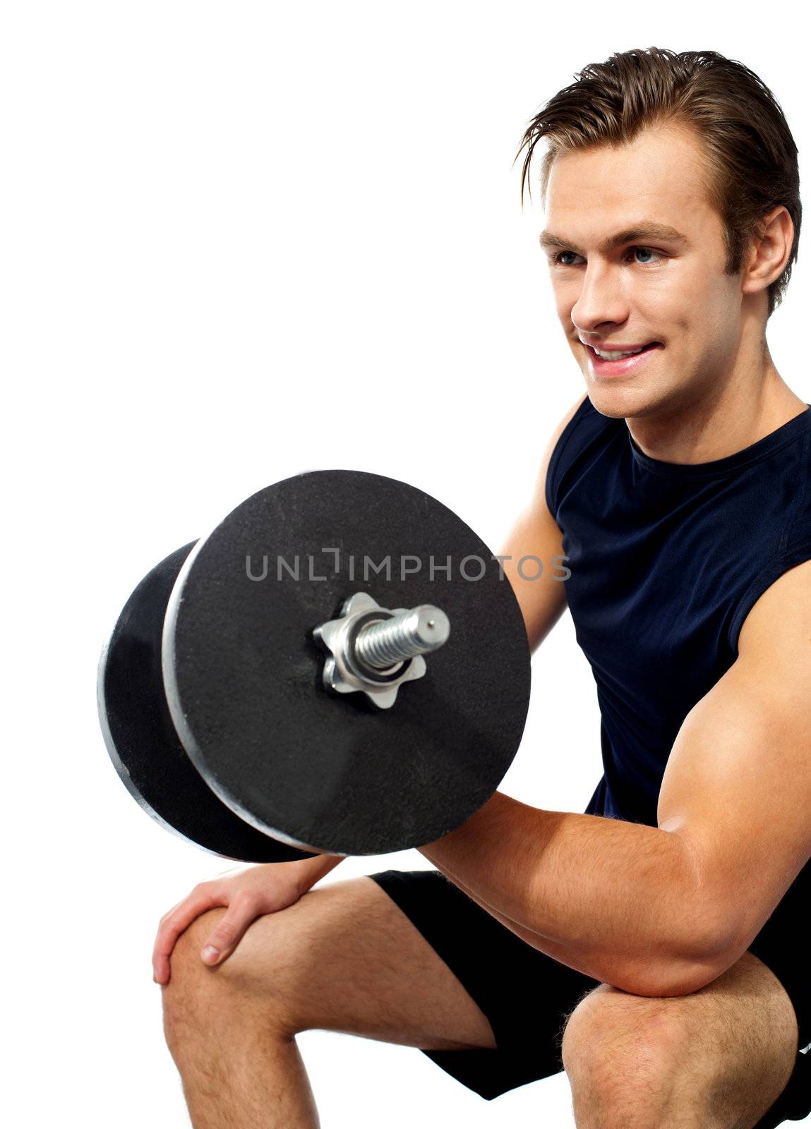 Strong young man working out with dumbbells. Shot in studio on a white background