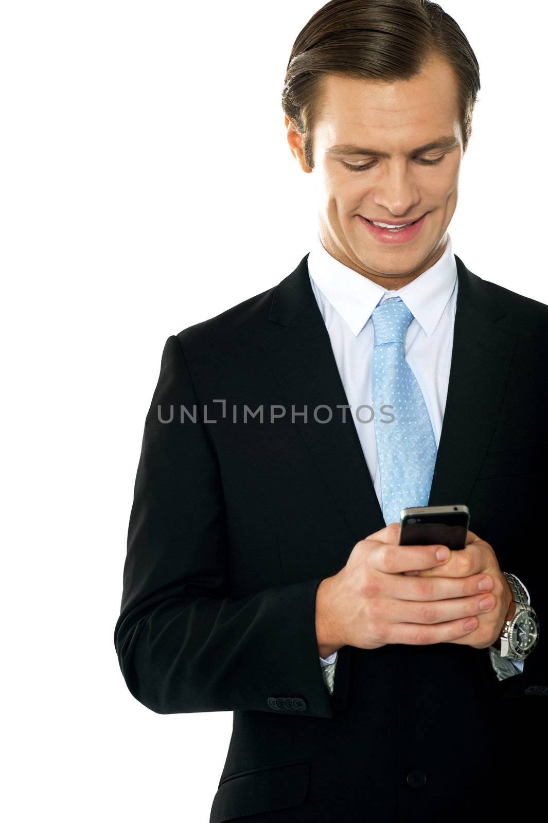 Confident businessperson messaging by stockyimages