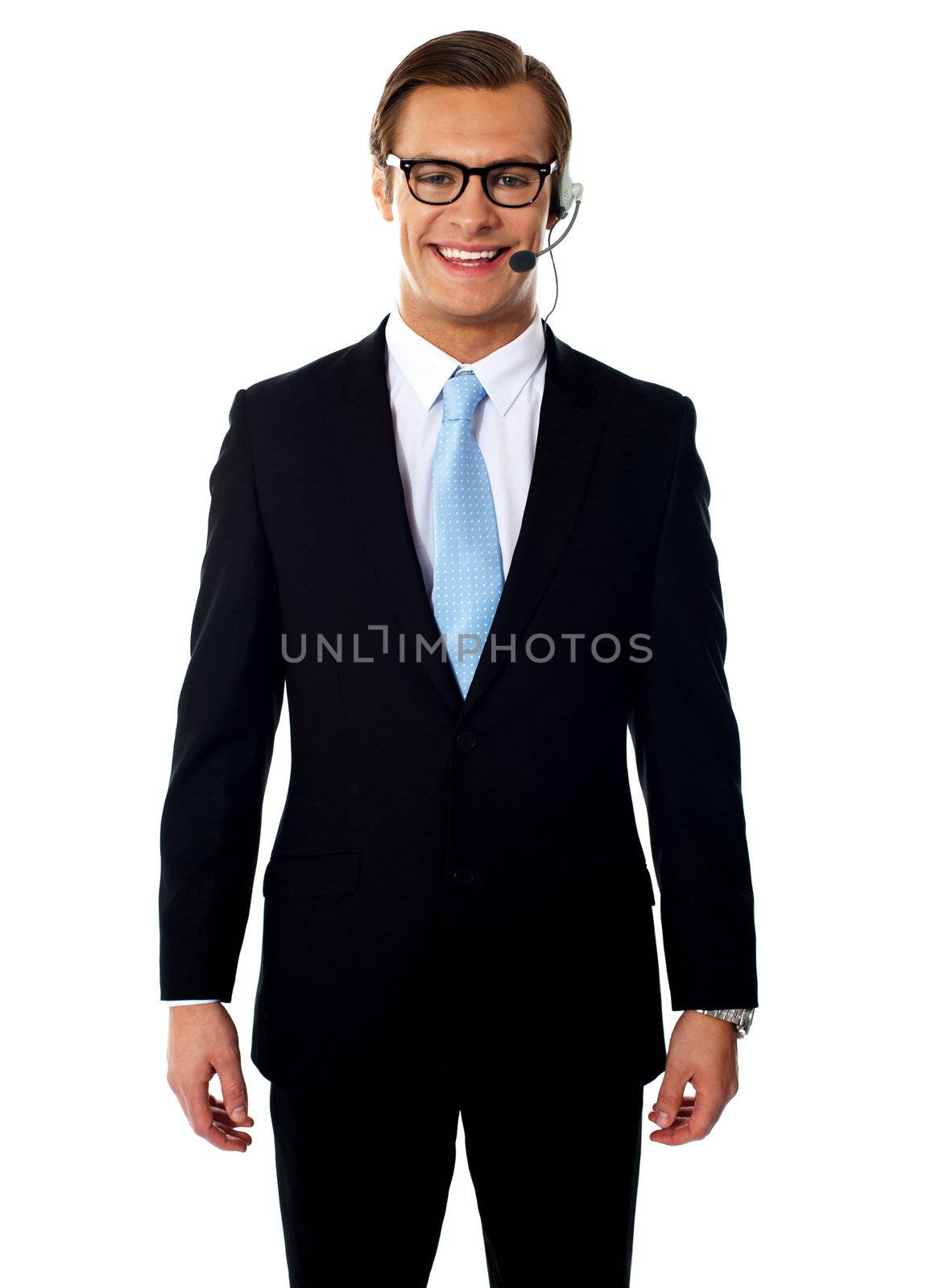 Male telemarketer posing in headsets, smiling by stockyimages