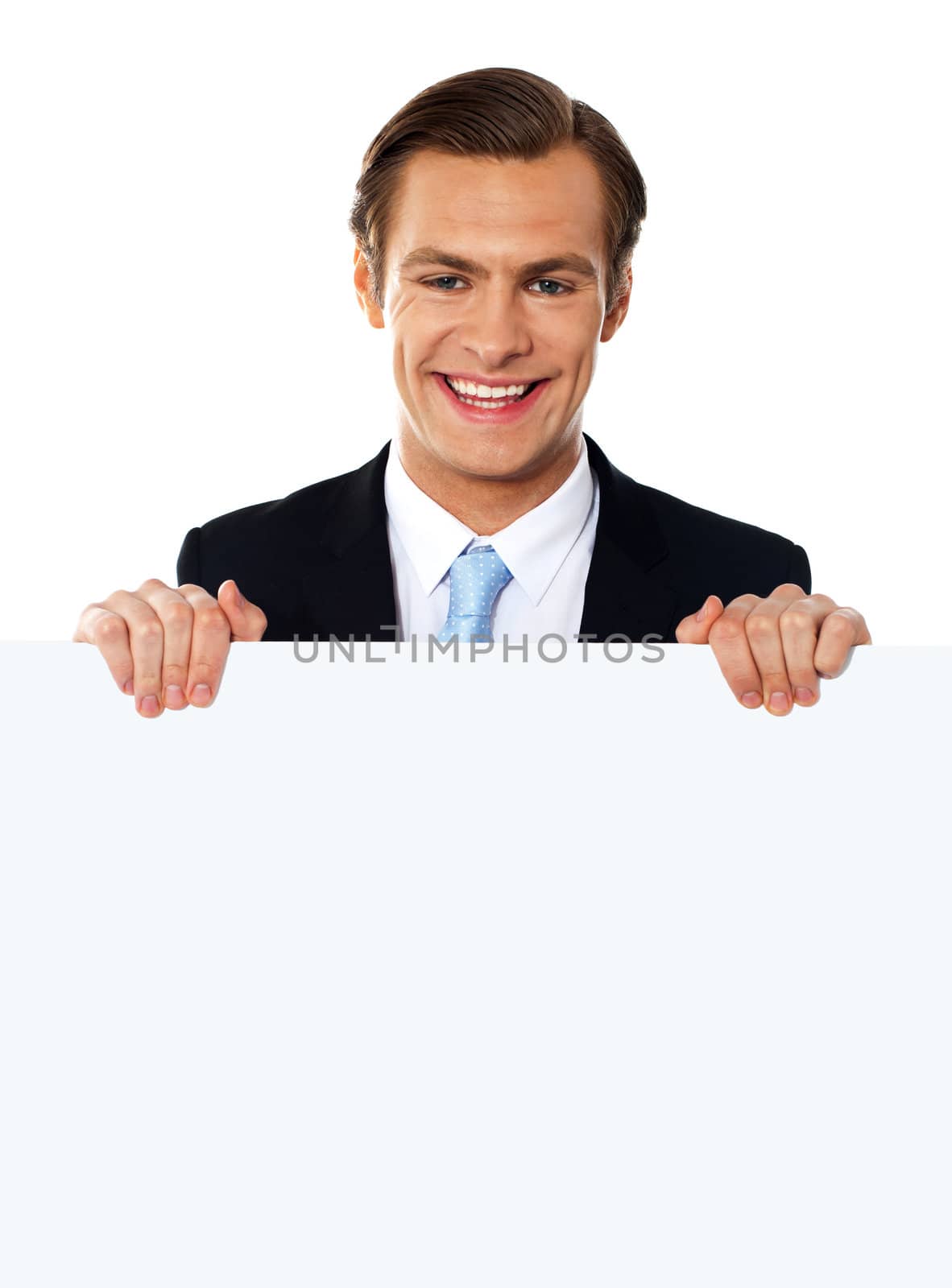 Cool businessman holding a blank poster by stockyimages