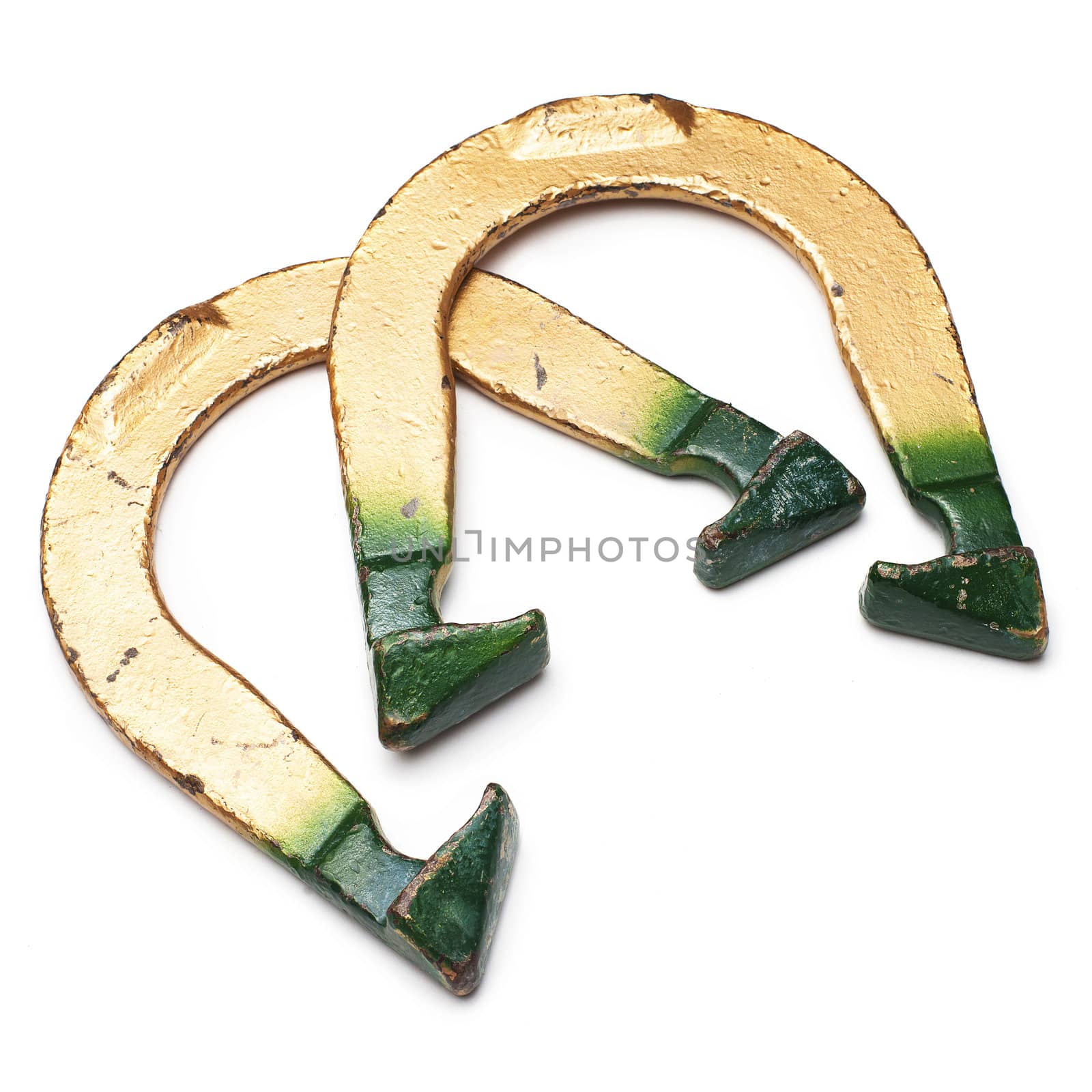 Two green and golden throwing horseshoes isolated on white 