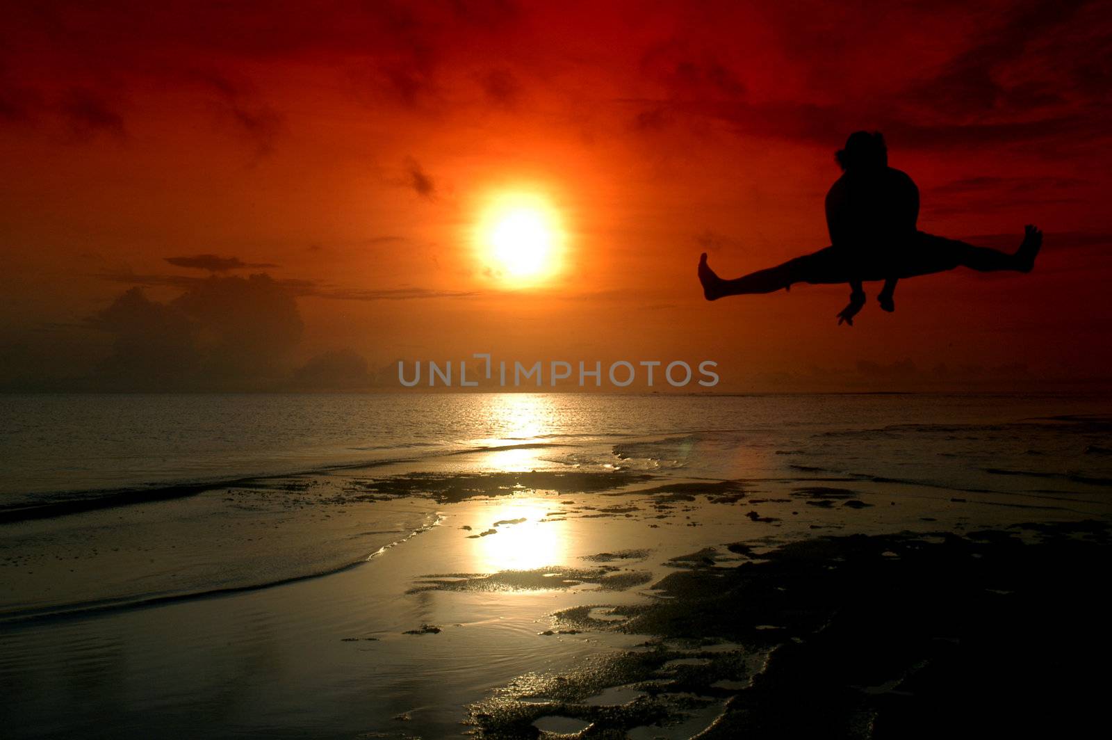 silhouette of a man jumping with sunrise baground by antonihalim