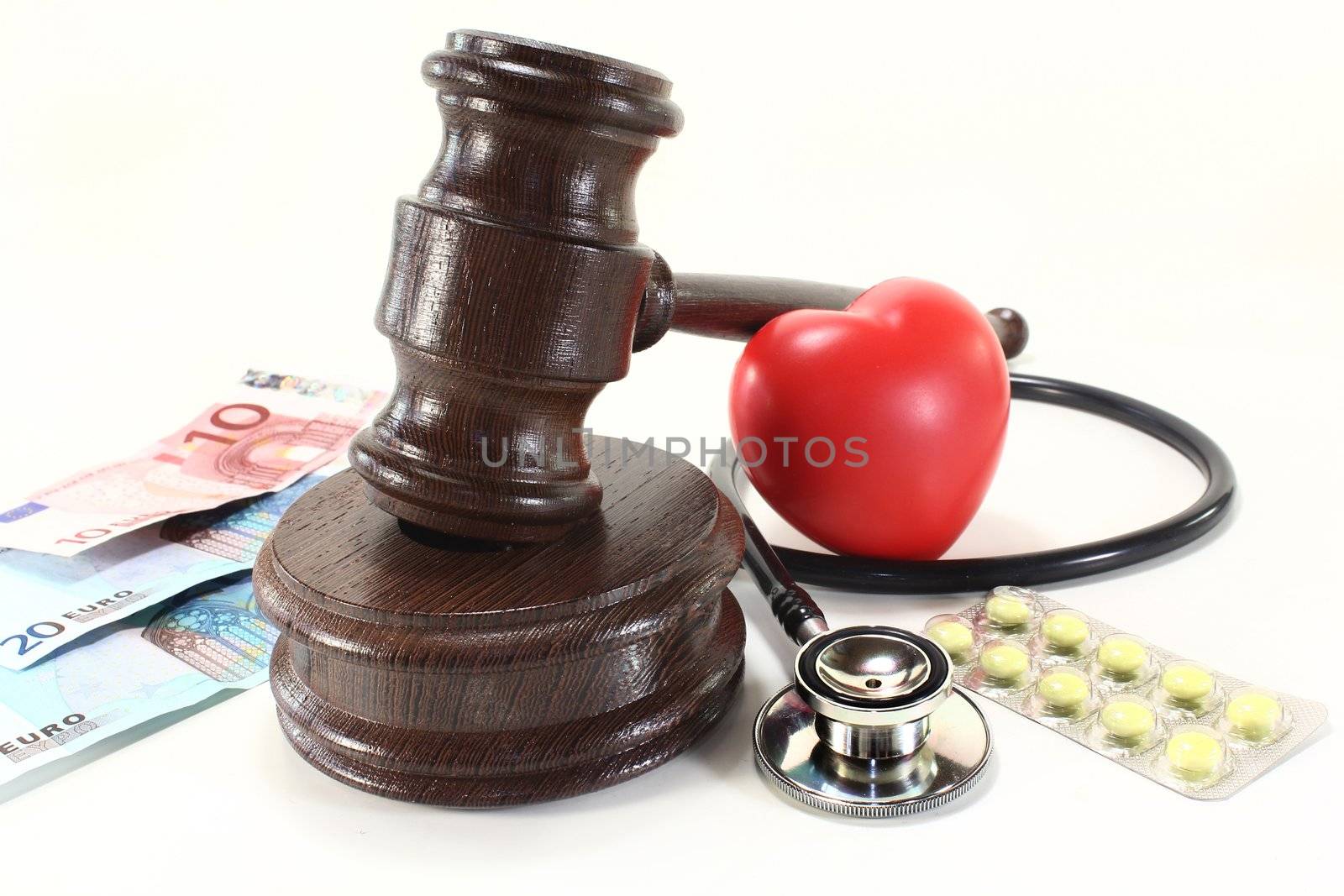 judges gavel with stethoscope and pills