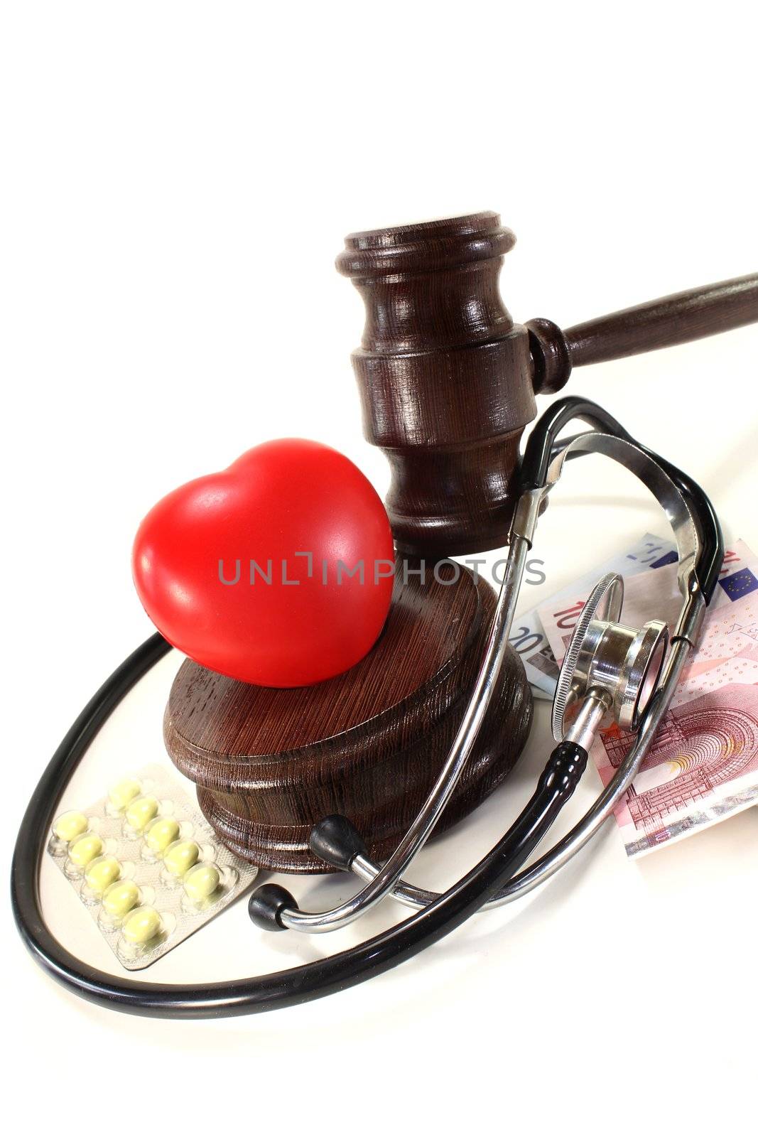 judges gavel with stethoscope and pills