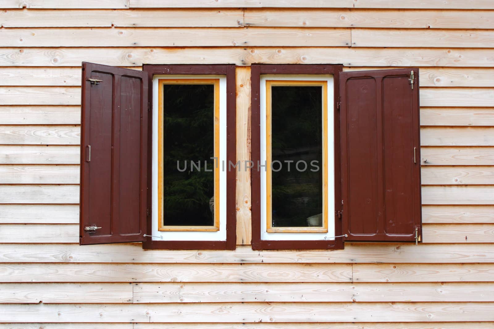wooden lodge window with the blinds opened