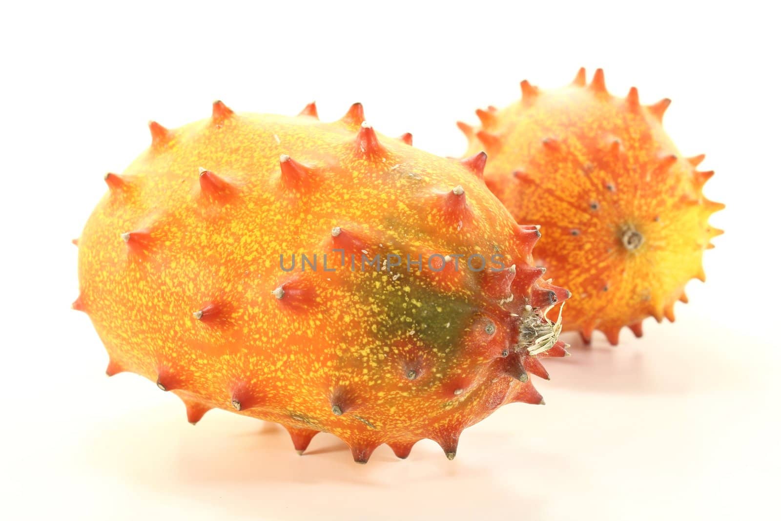 fresh raw orange Kiwano on a light background