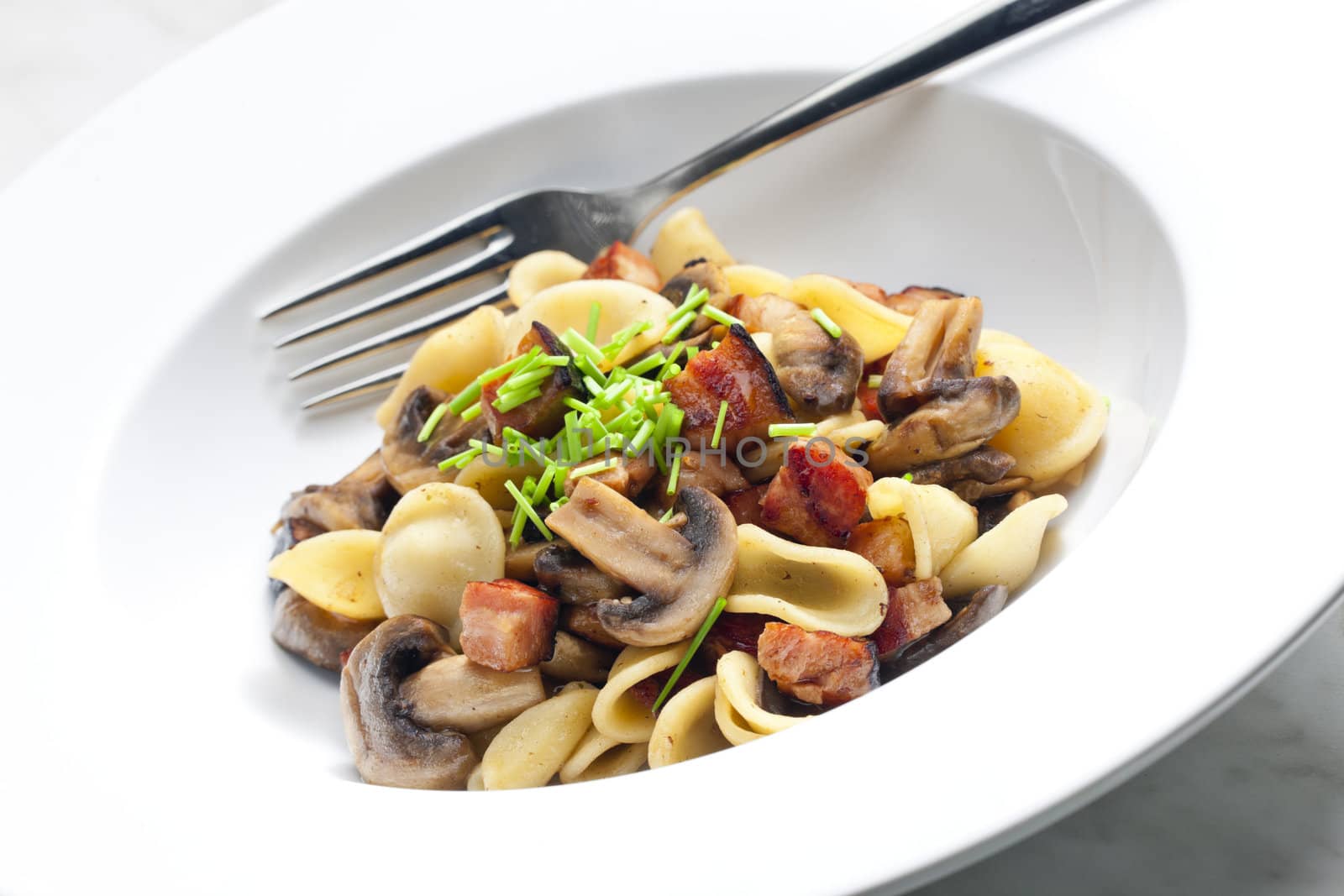 pasta orecchiette with fried champignons and bacon