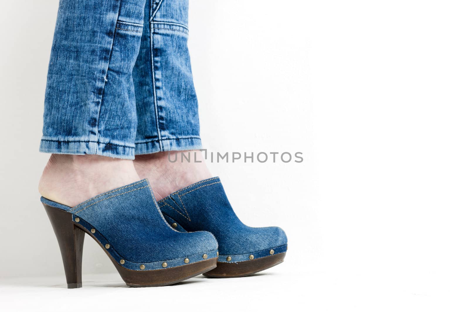detail of woman wearing denim clogs