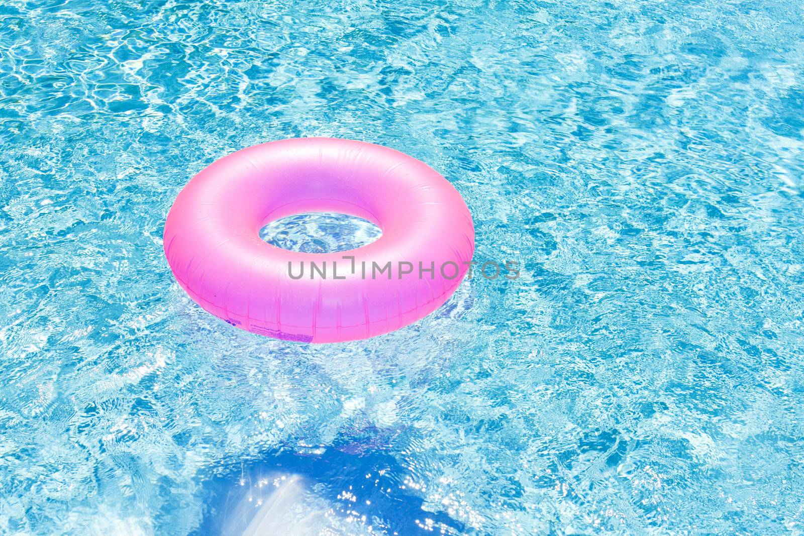 pink rubber ring in swimming pool