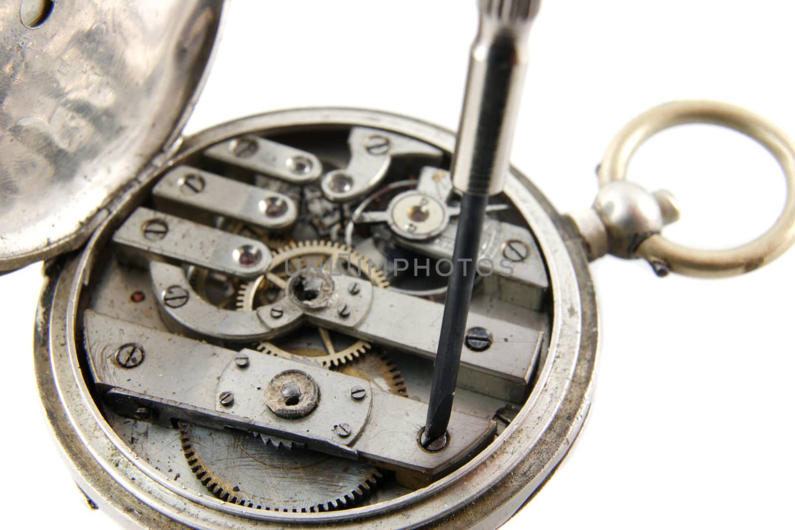 old pocket watch mechanism on a white background